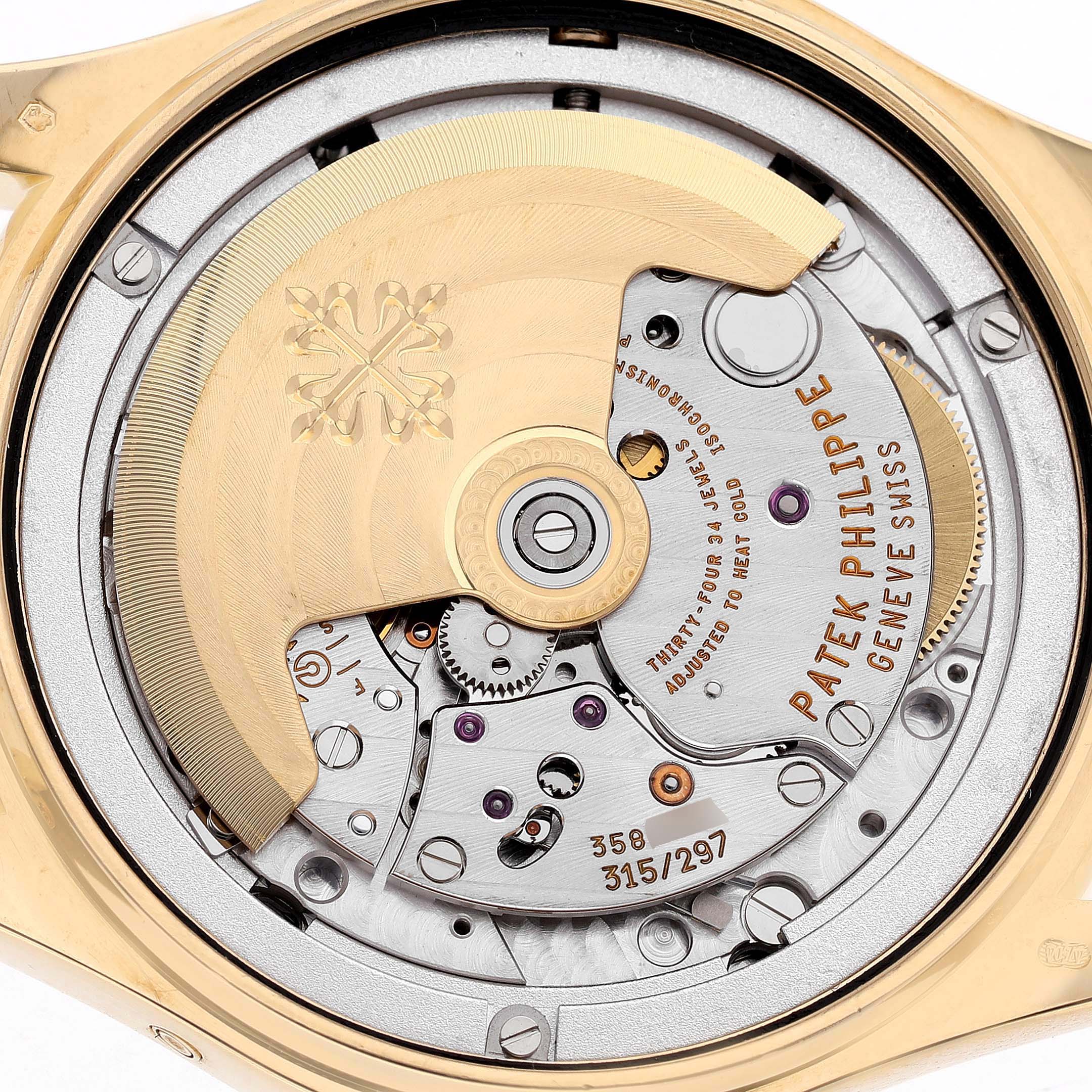 The image shows the rear view of a Patek Philippe Complications 4936J-001 Men's Yellow Gold Mother of Pearl Dial model, highlighting its intricate movement and rotor.