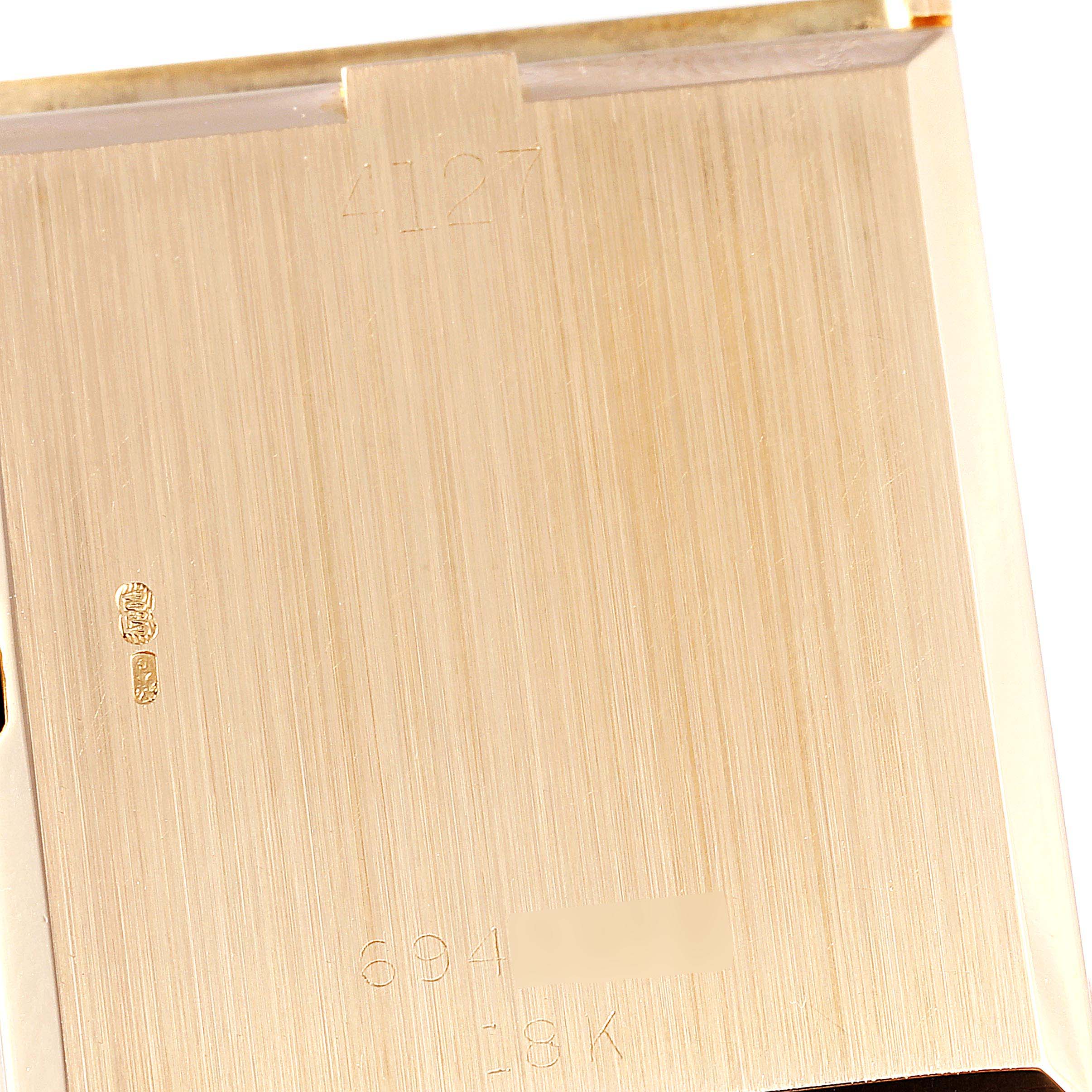 This image shows the inside of the case back of a Rolex Cellini 4127 Men's Yellow Gold Brown Dial 4127 Men's Yellow Gold Brown Dial watch, highlighting some engraving details including the model number and gold karat mark.