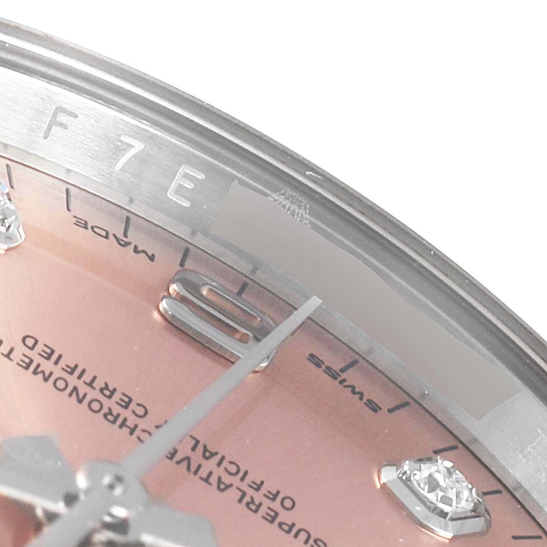 The image shows a close-up angle featuring the dial, hour markers, and part of the bezel of the Rolex Datejust 115234 Men's Stainless Steel Pink Dial 115234 Men's Stainless Steel Pink Dial.