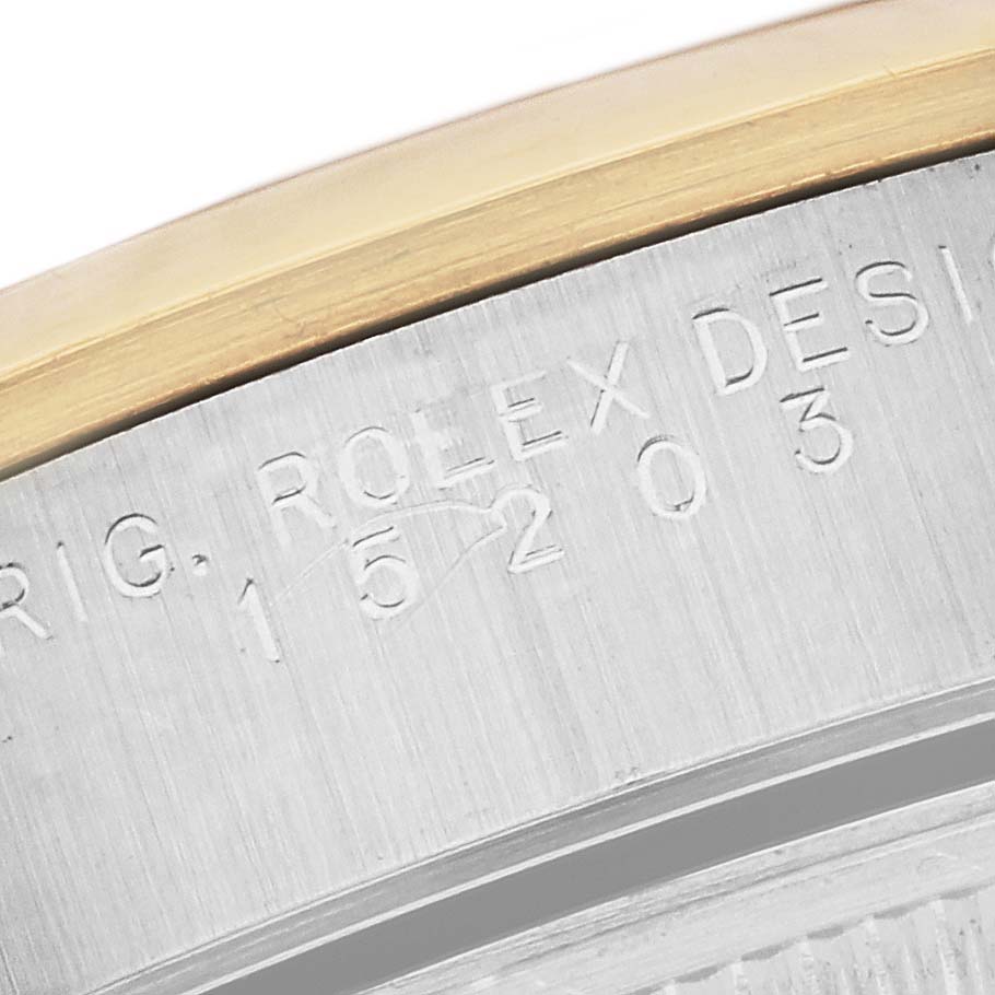 The image shows a close-up of the engraved case detailing and bezel of a Rolex Date 15203 Men's Steel and Gold (two tone) Silver Dial 15203 Men's Steel and Gold (two tone) Silver Dial model watch.