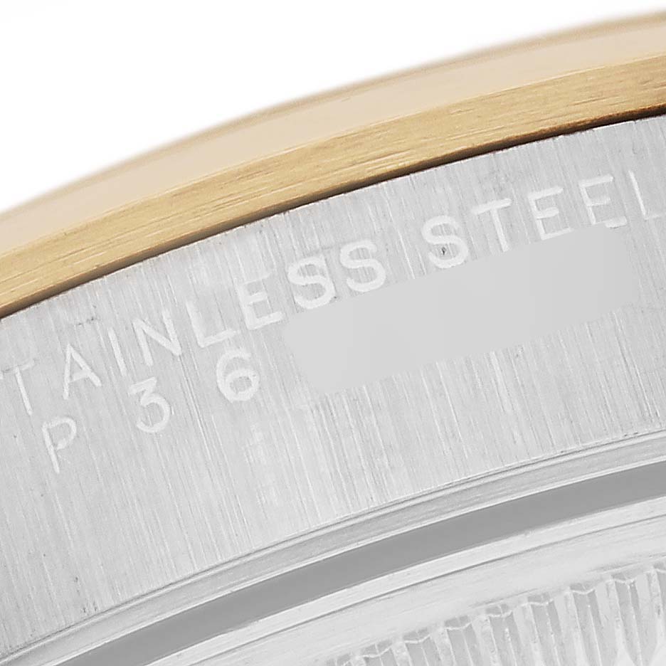 This image shows a close-up of the Rolex Date 15203 Men's Steel and Gold (two tone) Silver Dial 15203 Men's Steel and Gold (two tone) Silver Dial model's case edge, focusing on the engraved text "STAINLESS STEEL."