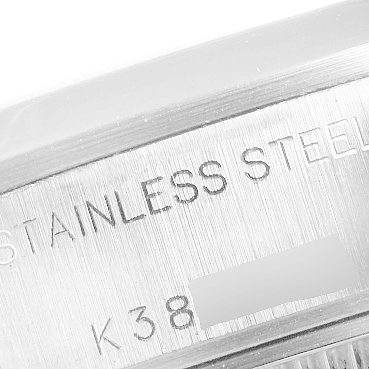 The image shows a close-up of the side of a Rolex Date 79160 Women
s Stainless Steel White Dial 79160 Women
s Stainless Steel White Dial model, highlighting the "Stainless Steel" inscription.