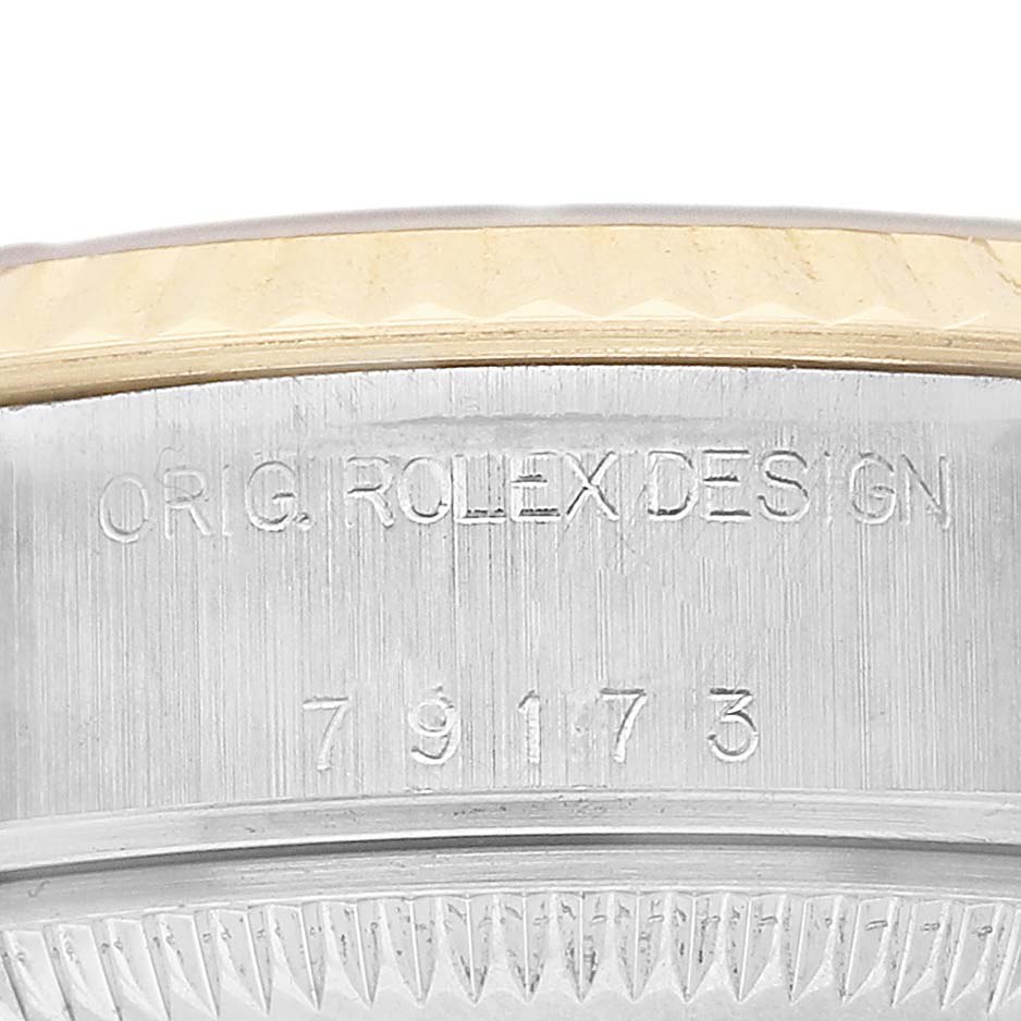 The image shows the engraved side of the Rolex Datejust 79173 Women's Stainless Steel White Dial case with "ORIG ROLEX DESIGN" and model number 79173.