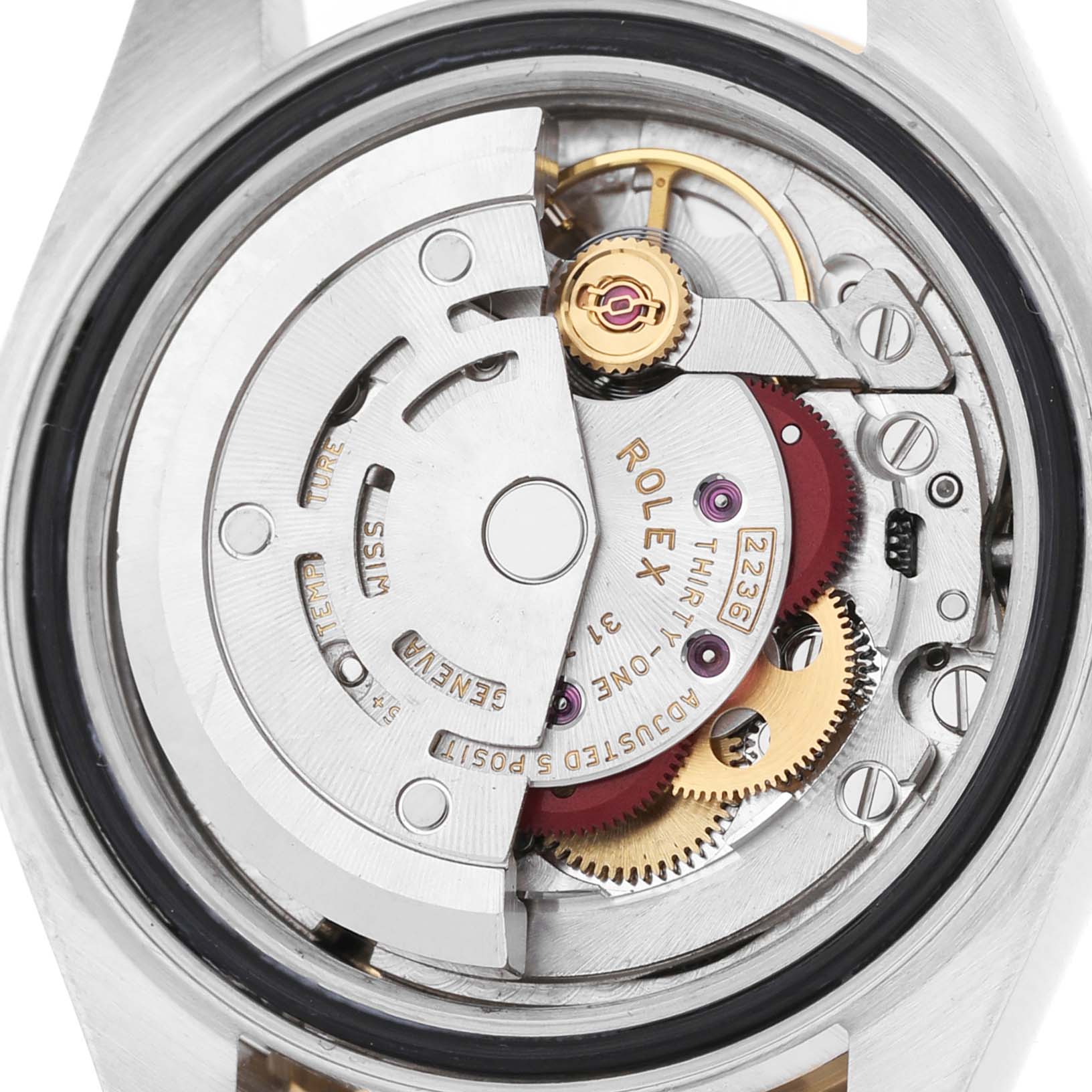 The image shows the movement from the back of a Rolex Datejust 279383 Women's Stainless Steel Champagne Dial, highlighting its intricate gears and mechanical parts.