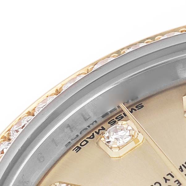 The image shows a close-up of a Rolex Datejust 279383 Women's Stainless Steel Champagne Dial, highlighting the diamond-set bezel and part of the gold dial with diamond hour markers.
