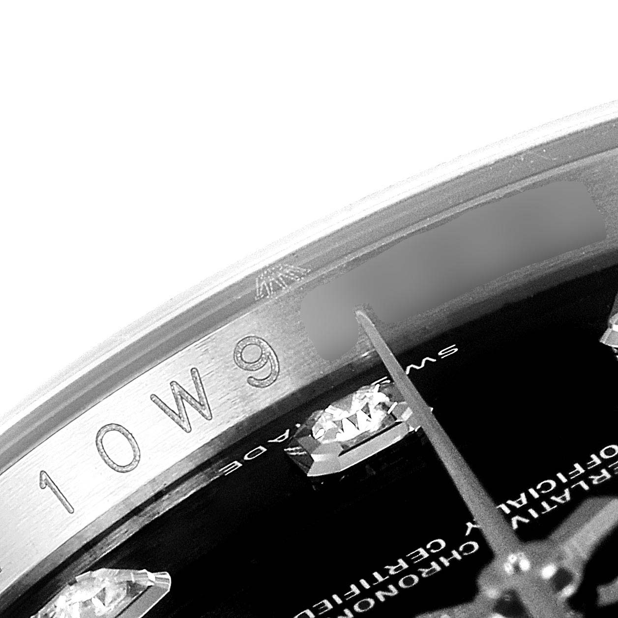 The image shows a close-up of the bezel and part of the dial of a Rolex Datejust 116244 Men's Stainless Steel Black Dial 116244 Men's Stainless Steel Black Dial watch.