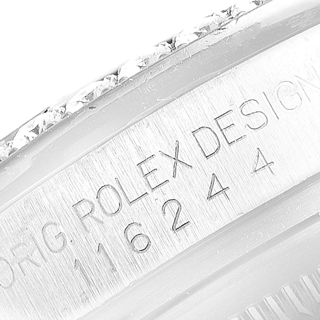 The image shows an angled close-up of the Rolex Datejust 116244 Men's Stainless Steel Black Dial 116244 Men's Stainless Steel Black Dial watch case, displaying the engraved "ROLEX DESIGN" and serial number.