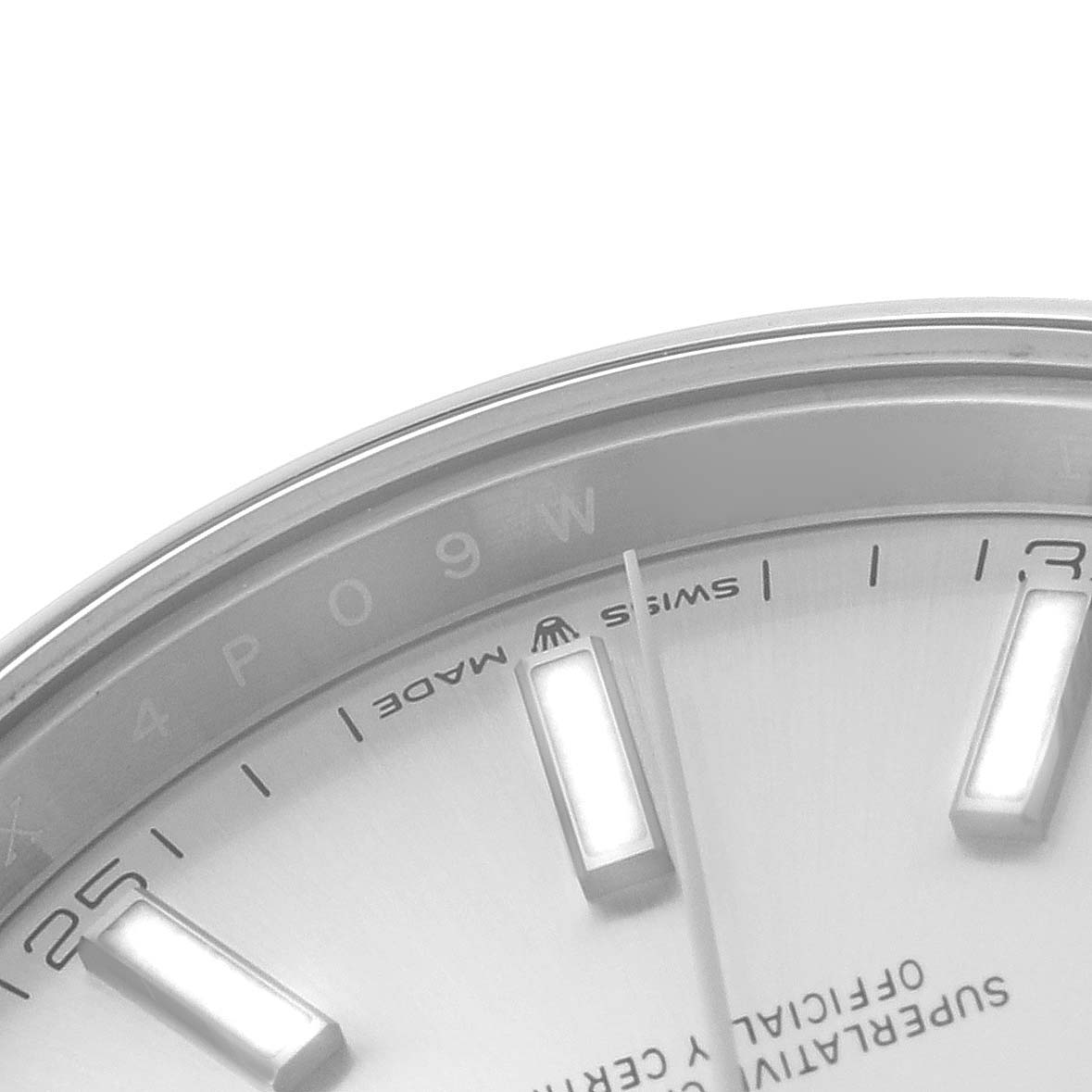 The image shows a close-up of the upper left section of the dial of a Rolex Datejust 41 126300 Men
s Stainless Steel Silver Dial 126300 Men
s Stainless Steel Silver Dial watch, displaying part of the hour markers and text.