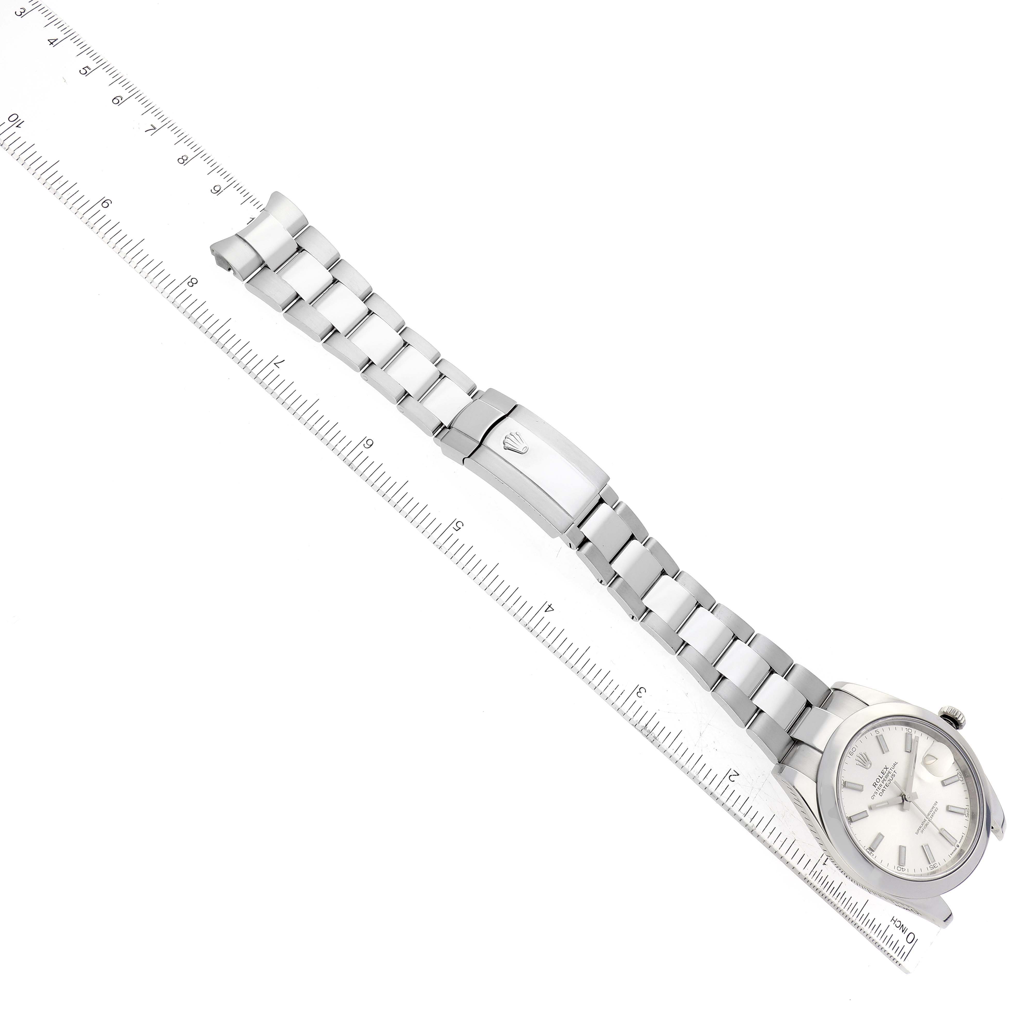 The image shows a Rolex Datejust 41 126300 Men
s Stainless Steel Silver Dial 126300 Men
s Stainless Steel Silver Dial watch, displayed diagonally and including the bezel, dial, bracelet, and clasp alongside a ruler for size reference.