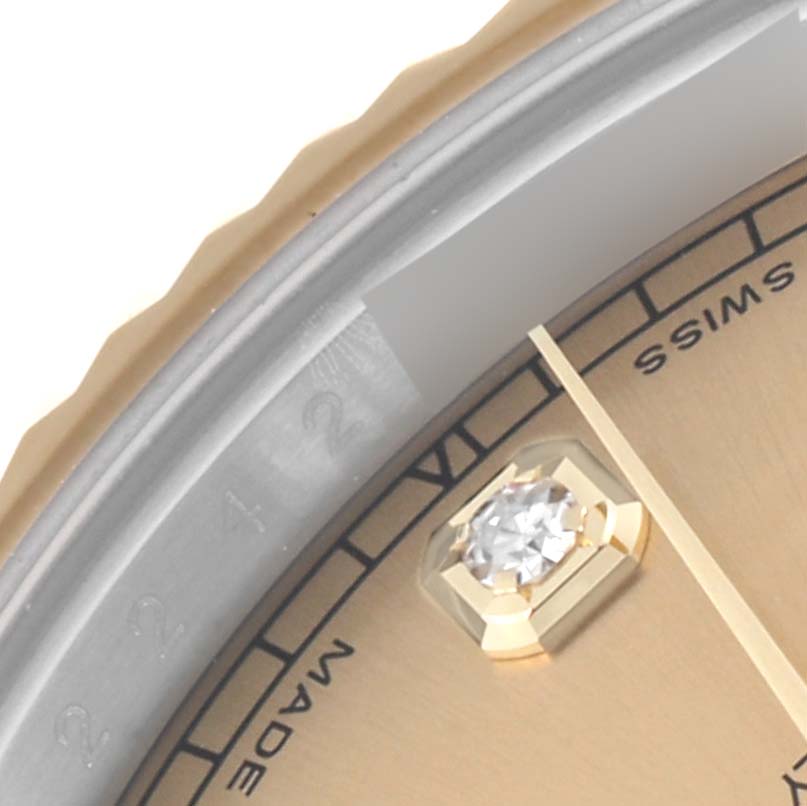 This close-up image of the Rolex Datejust 41 116333 Men's Steel and Gold (two tone) Champagne Dial 116333 Men's Steel and Gold (two tone) Champagne Dial model shows part of the watch's dial and bezel, highlighting a diamond hour marker.