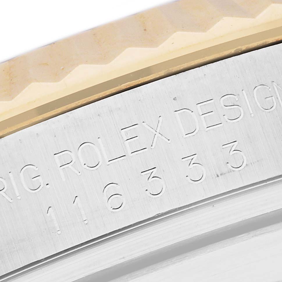 The image shows a close-up of the bezel and the engraved side of the case of a Rolex Datejust 41 116333 Men's Steel and Gold (two tone) Grey Dial 116333 Men's Steel and Gold (two tone) Grey Dial model.
