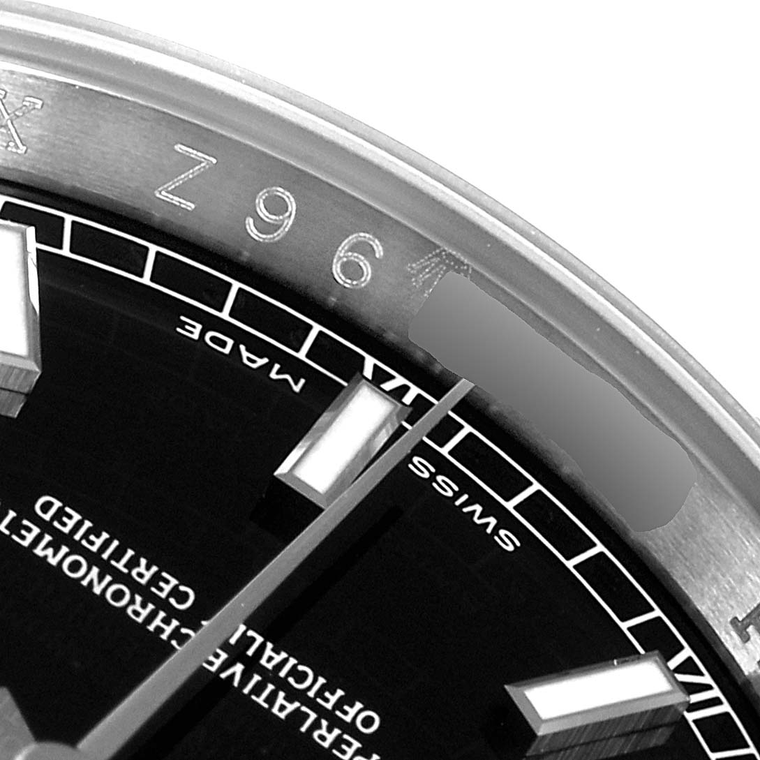 The image shows a close-up of the dial and bezel with part of the serial number of a Rolex Datejust 116234 Men's Stainless Steel Black Dial 116234 Men's Stainless Steel Black Dial watch.