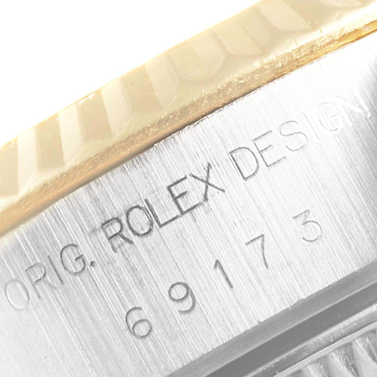 Close-up of the side of a Rolex Datejust 69173 Women's Steel and Gold (two tone) Champagne Dial 69173 Women's Steel and Gold (two tone) Champagne Dial watch showing the engraved model number and brand name on the metal band.