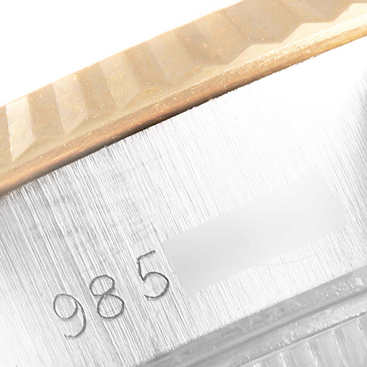 This image shows a close-up of the case and fluted bezel of a Rolex Datejust 69173 Women's Steel and Gold (two tone) Champagne Dial 69173 Women's Steel and Gold (two tone) Champagne Dial watch.