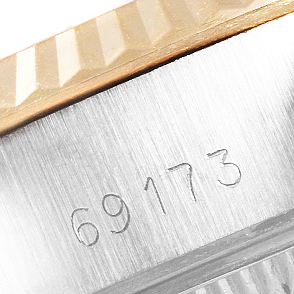 Close-up of the side of a Rolex Datejust 69173 Women's Steel and Gold (two tone) Champagne Dial 69173 Women's Steel and Gold (two tone) Champagne Dial watch, showing the model number "69173" and part of the bezel.