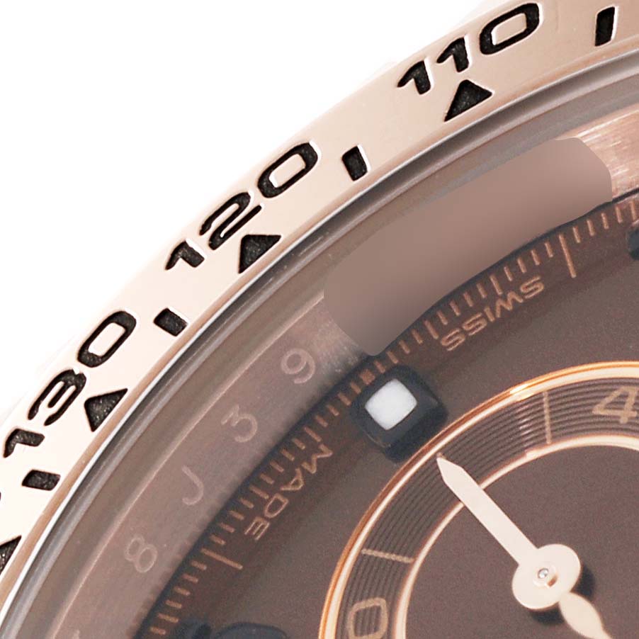 The image shows a close-up of the bezel and partial dial of a Rolex Daytona 116505 Men's Rose Gold Brown Dial 116505 Men's Rose Gold Brown Dial watch, with visible numbers and markings.
