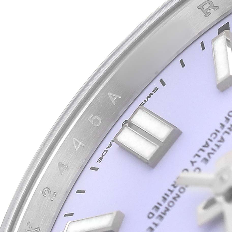 The image shows a close-up of the Rolex Oyster Perpetual 134300 Men's Stainless Steel Purple Dial watch's bezel, dial, and indices from an angled view.
