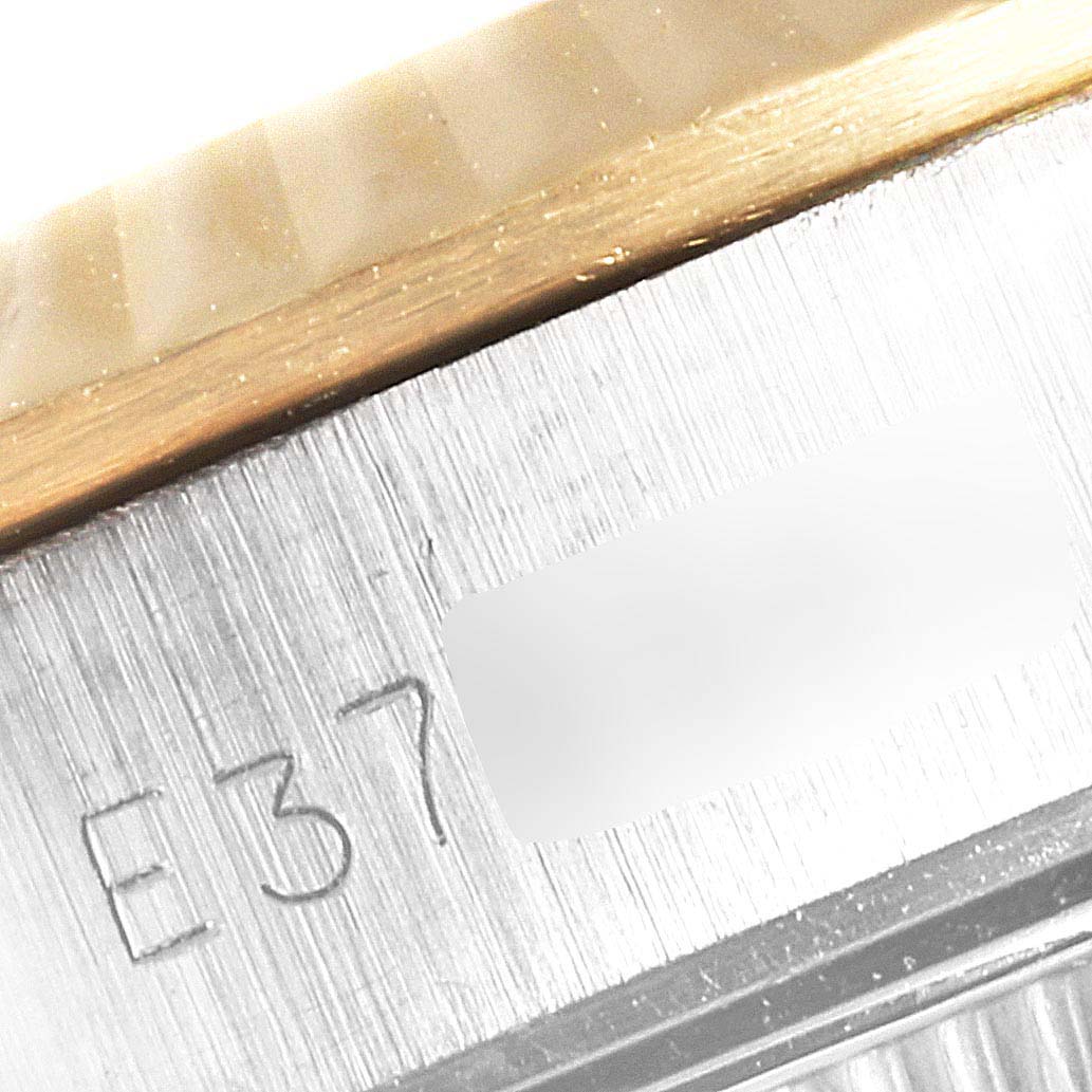 This close-up image shows the side case, part of the bezel, and engraving details of the Rolex Oyster Perpetual 67193 Women
s Steel and Gold (two tone) Champagne Dial 67193 Women
s Steel and Gold (two tone) Champagne Dial watch.