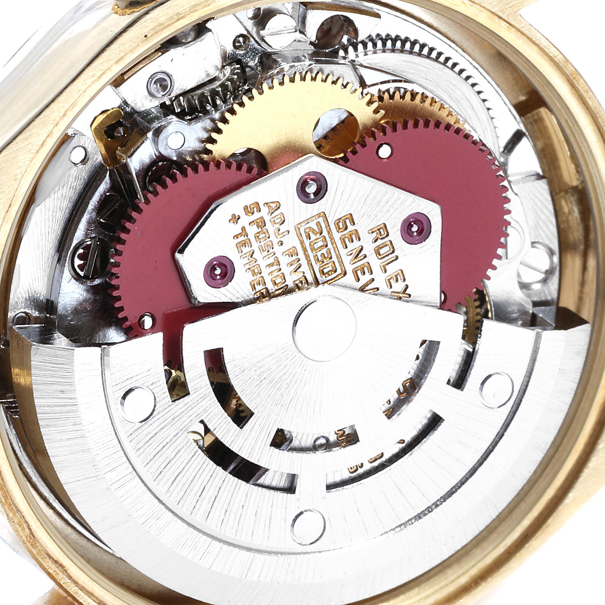 This image shows the internal mechanical parts of the Rolex Oyster Perpetual 6719 Women's Yellow Gold Silver Dial 6719 Women's Yellow Gold Silver Dial watch, including gears and the rotor.