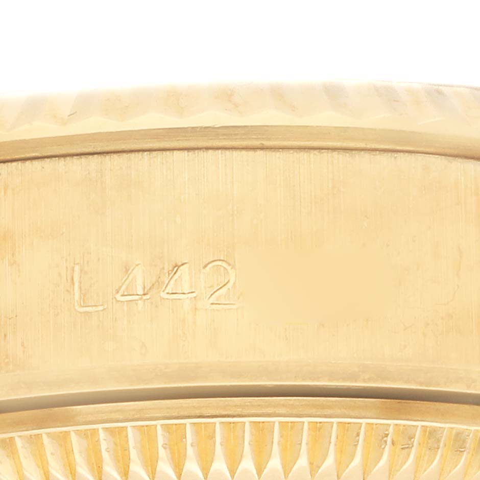 This image shows a close-up of the caseback edge, and serial number engraving of a Rolex President 69178 Women's Yellow Gold Champagne Dial 69178 Women's Yellow Gold Champagne Dial model watch.
