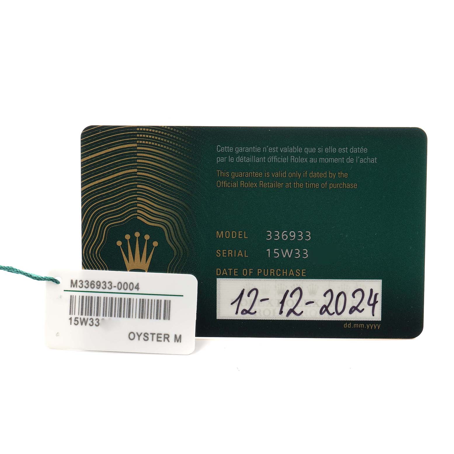 The image shows a green Rolex guarantee card and a tag for a Sky-Dweller, model number 336933.