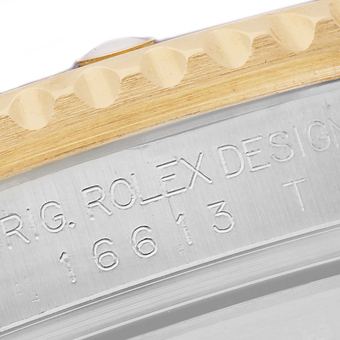 The image shows a close-up of the case side and bezel of a Rolex Submariner 16613 Men's Steel and Gold (two tone) Blue Dial 16613 Men's Steel and Gold (two tone) Blue Dial model, featuring engraved text.