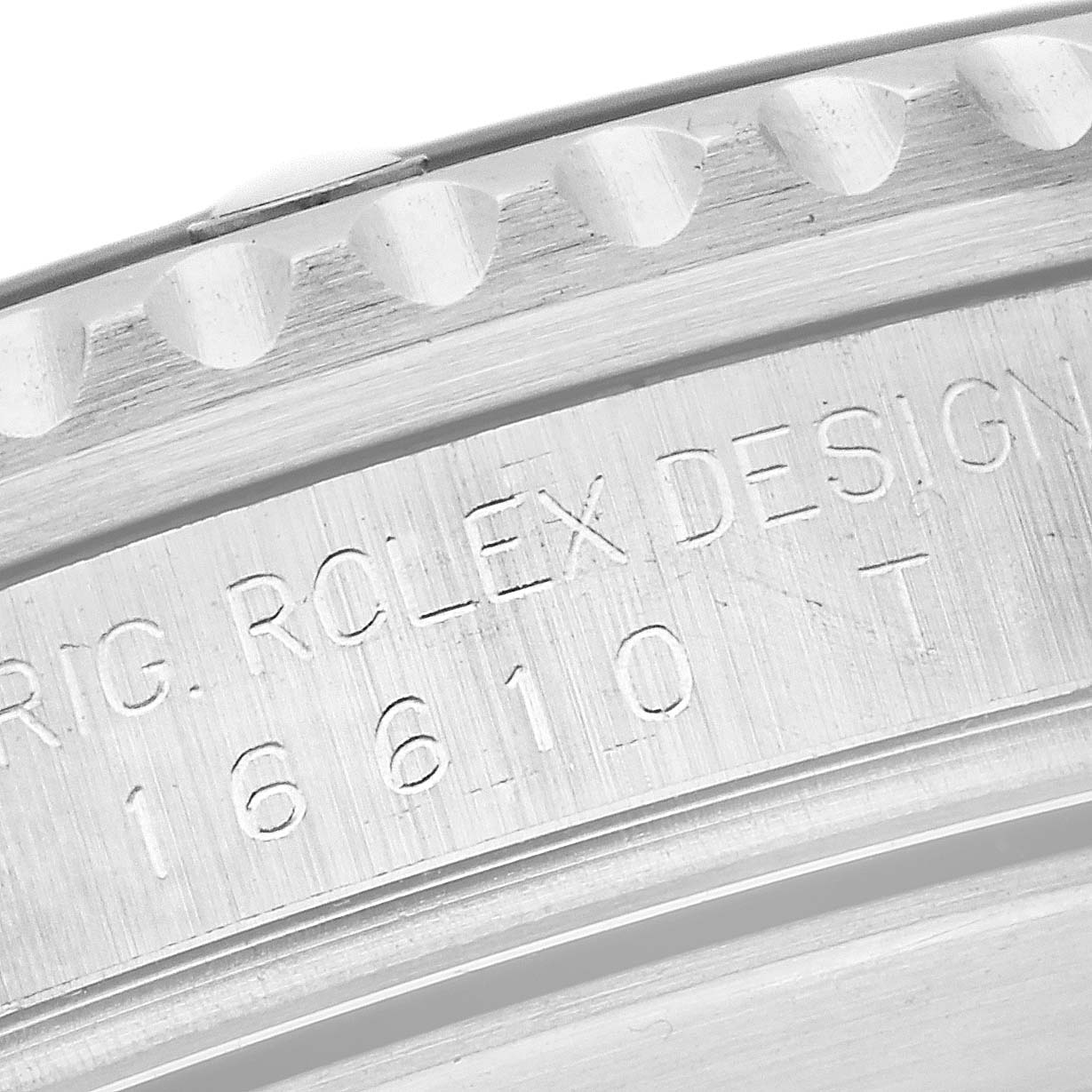 The image shows a close-up view of the engraving on the side of a Rolex Submariner 16610 Men
s Stainless Steel Black Dial 16610 Men
s Stainless Steel Black Dial watch case, including the model number.