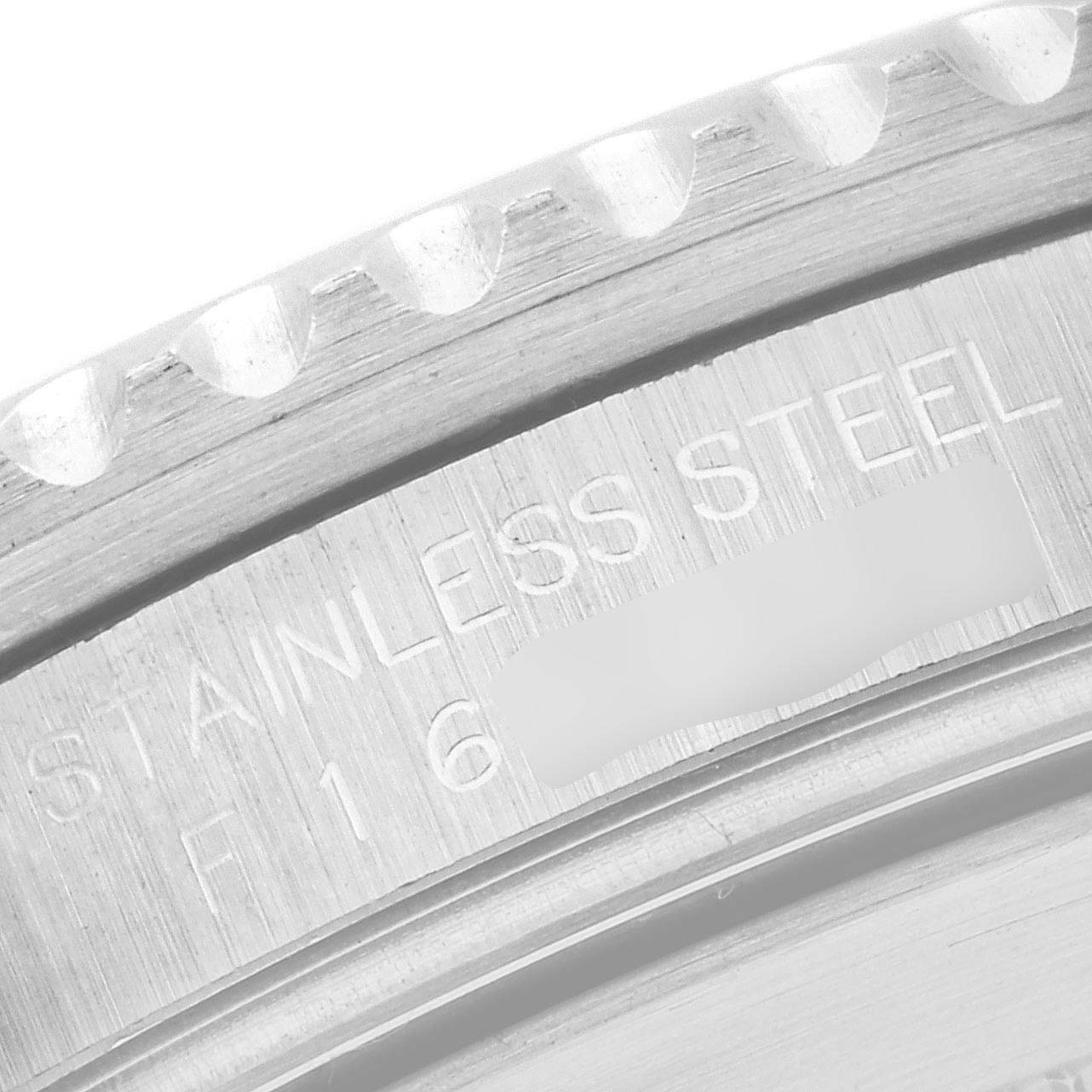 This image shows a close-up of the case back edge of a Rolex Submariner 16610 Men
s Stainless Steel Black Dial 16610 Men
s Stainless Steel Black Dial, highlighting the "Stainless Steel" engraving.