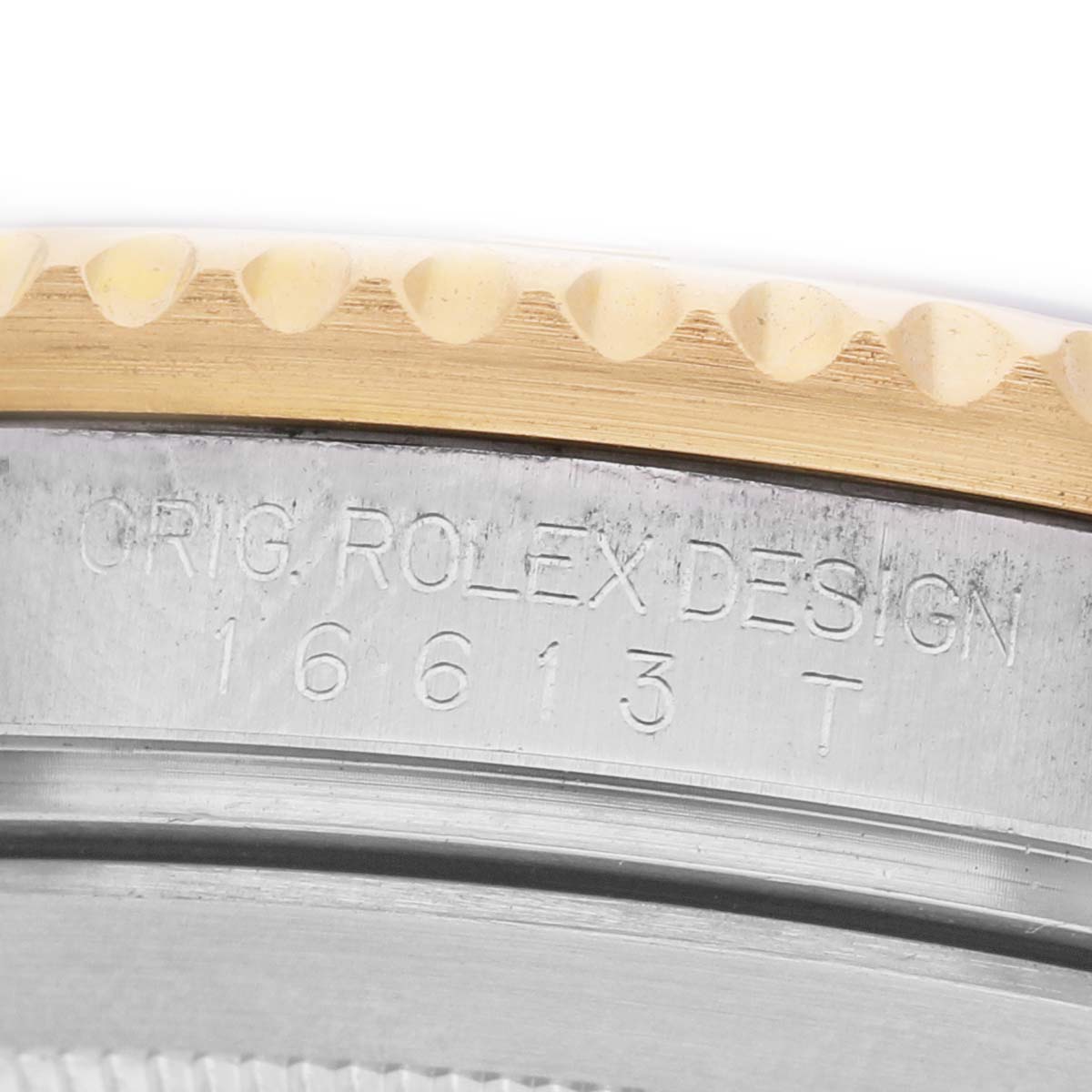 This close-up image shows the engraved side of the bezel and case of a Rolex Submariner 16613 Men's Steel and Gold (two tone) Blue Dial, highlighting model details.