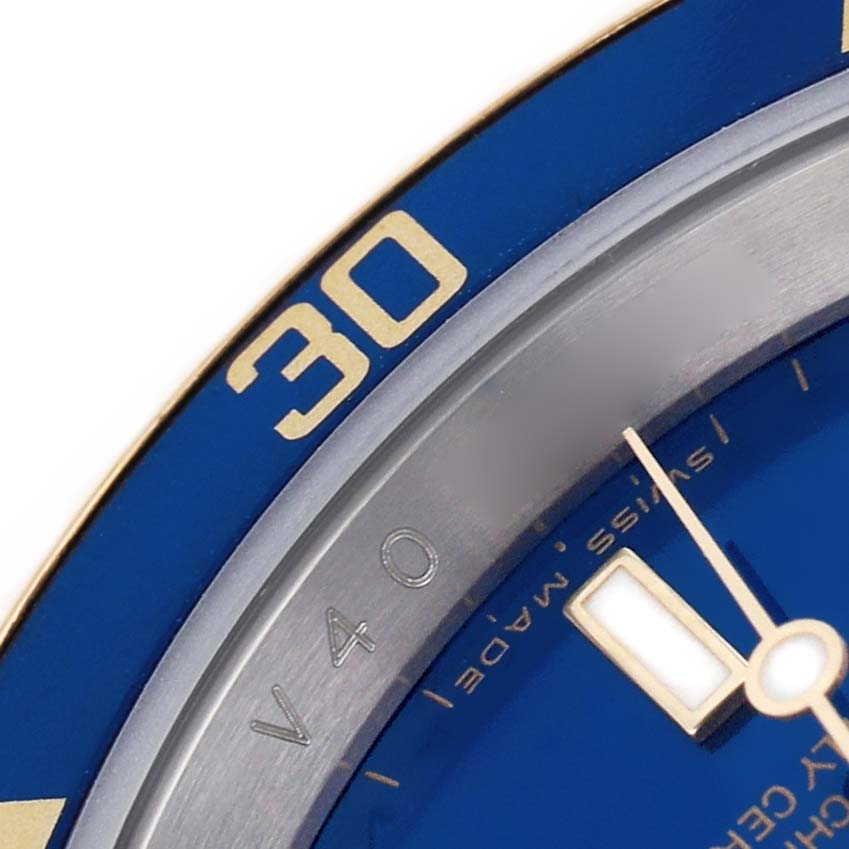 The image shows a close-up of the blue bezel and part of the dial of a Rolex Submariner 16613 Men's Steel and Gold (two tone) Blue Dial.