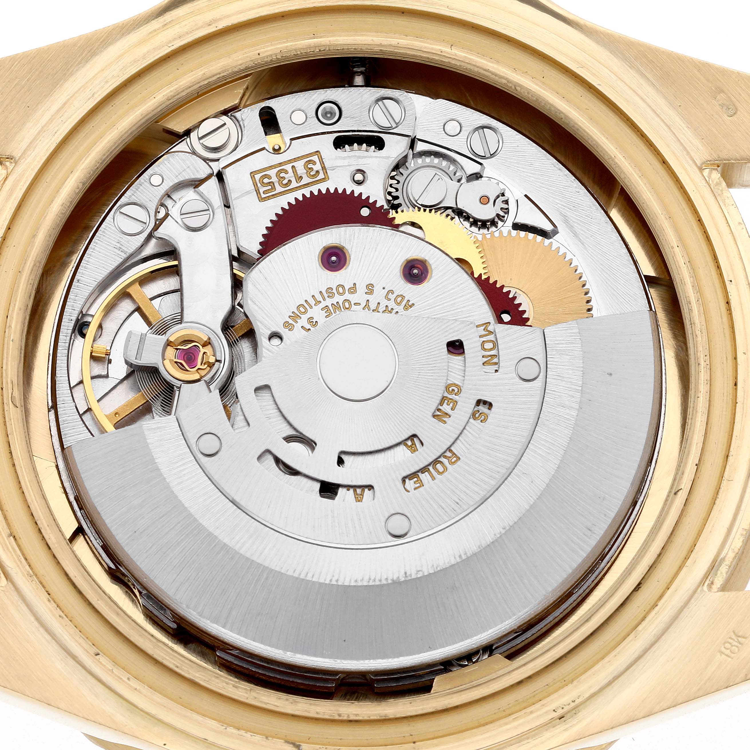 The image shows the open case back view of a Rolex Submariner 16618 Men's Yellow Gold Blue Dial 16618 Men's Yellow Gold Blue Dial, revealing its intricate movement parts and mechanisms.