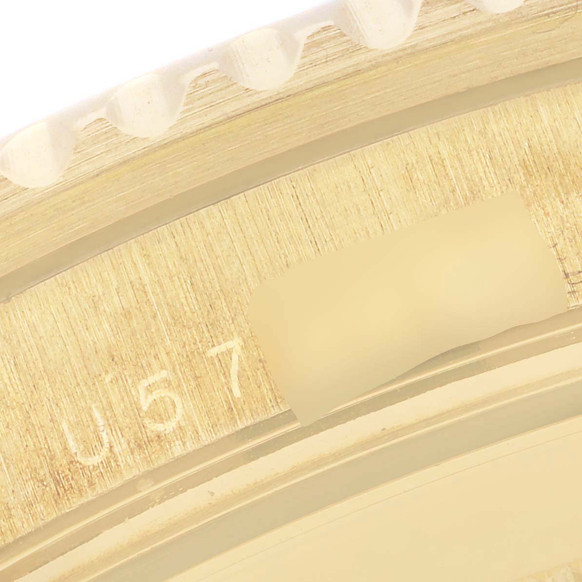 This is a close-up of the engraved serial number on the bezel edge of a Rolex Submariner 16618 Men's Yellow Gold Blue Dial 16618 Men's Yellow Gold Blue Dial watch.
