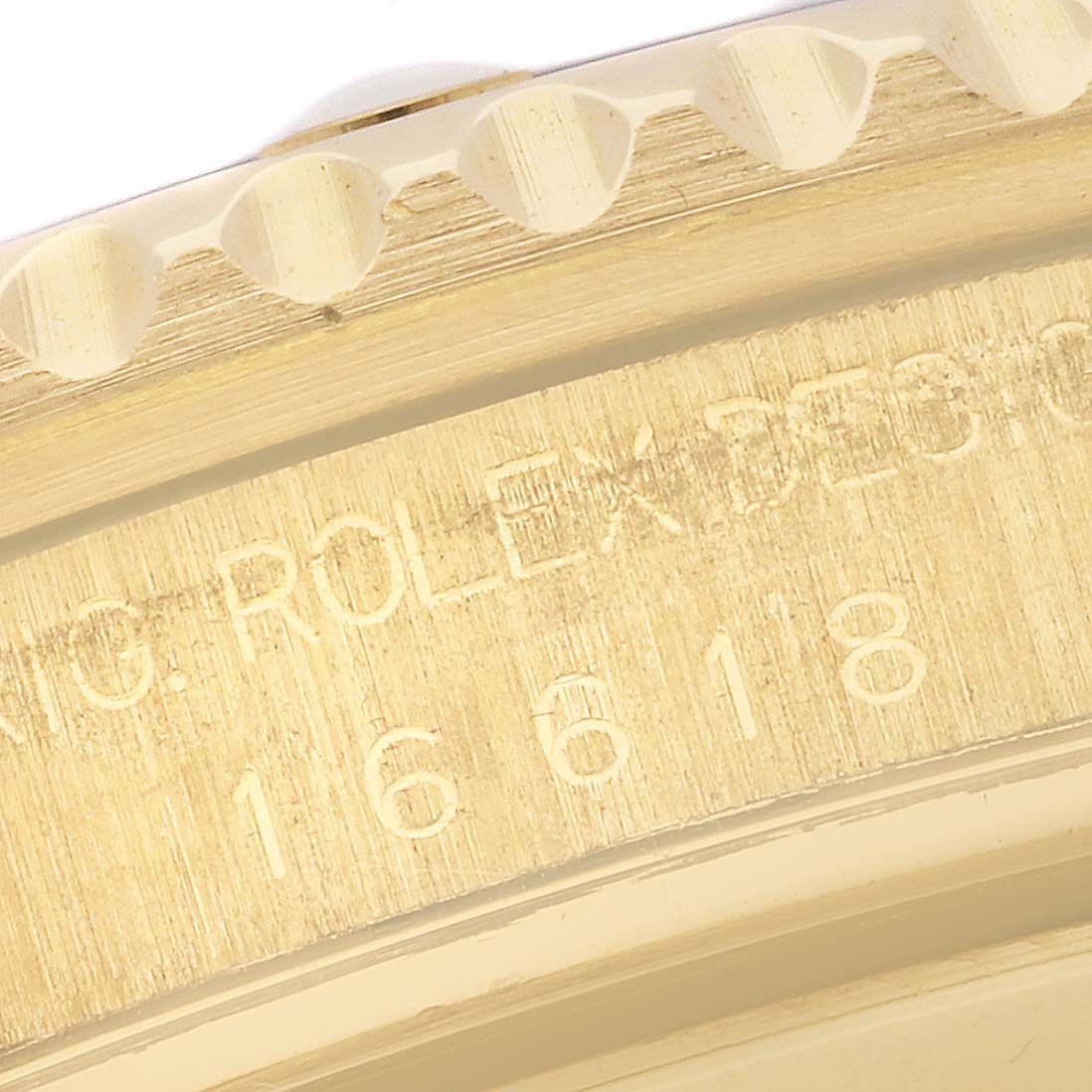 Close-up of the watch case engraving showing the model number and brand inscription on a Rolex Submariner 16618 Men's Yellow Gold Blue Dial 16618 Men's Yellow Gold Blue Dial.