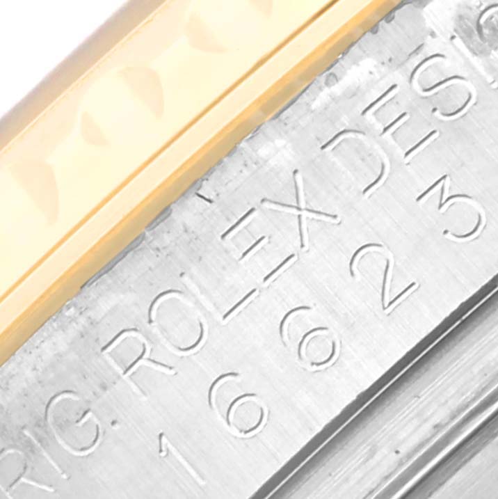 This image shows an up-close view of the bezel and engraving on the case of a Rolex Yacht-Master 16623 Men's Steel and Gold (two tone) Blue Dial 16623 Men's Steel and Gold (two tone) Blue Dial watch.