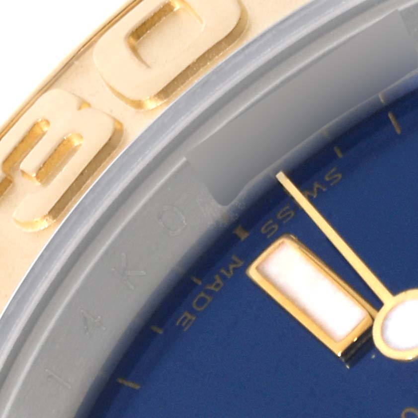 The image shows a close-up of the bezel and part of the dial of a Rolex Yacht-Master 16623 Men's Steel and Gold (two tone) Blue Dial 16623 Men's Steel and Gold (two tone) Blue Dial watch, including the 'SWISS MADE' label.