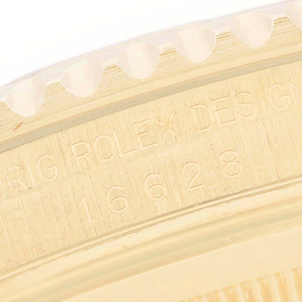 This image shows a close-up view of the side of a Rolex Yacht-Master 16628 Men's Yellow Gold White Dial 16628 Men's Yellow Gold White Dial watch, highlighting the bezel and engraved model number.