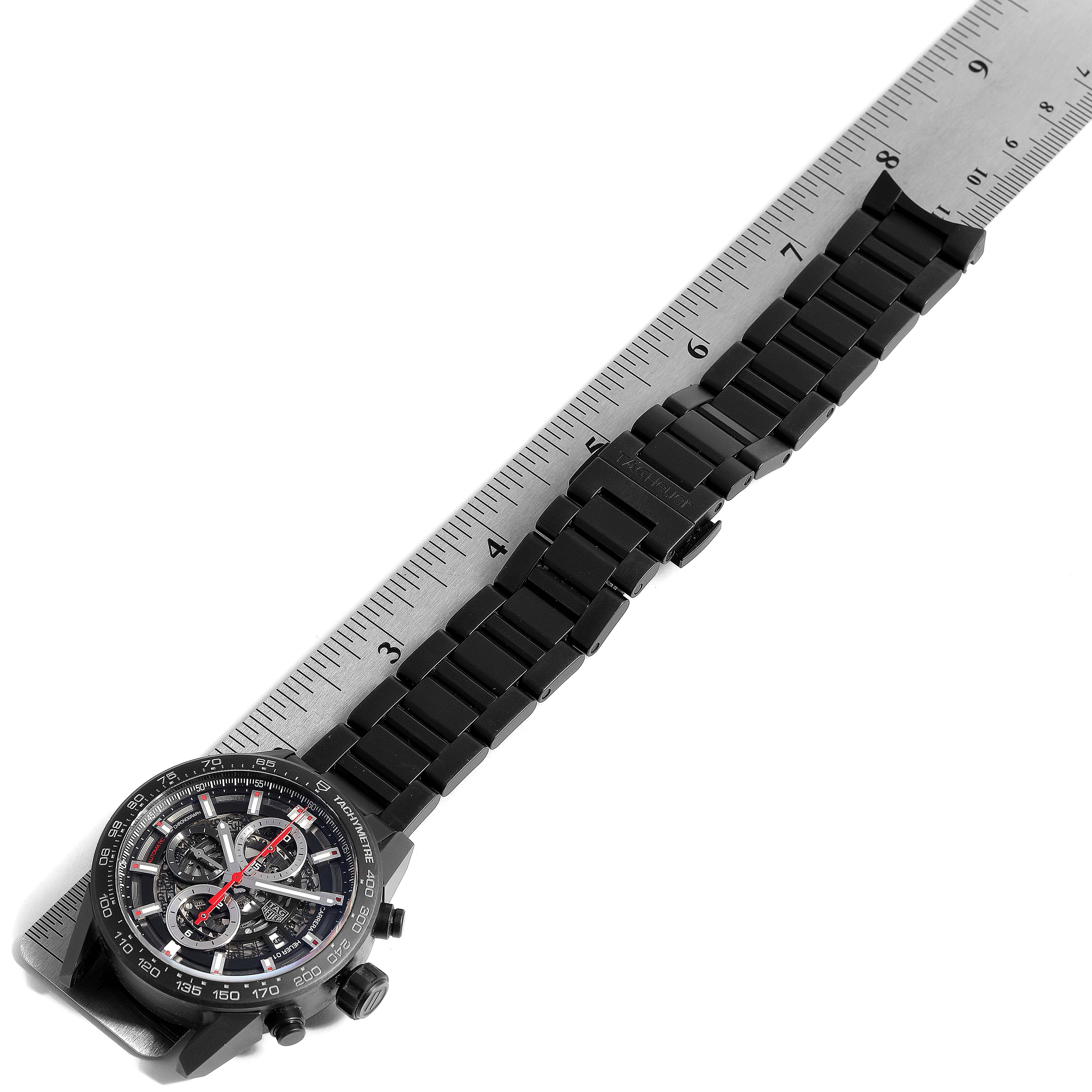 The image shows a top-down view of a Tag Heuer Carrera CAR2090.BH0729 Men's Titanium Black Dial CAR2090.BH0729 Men's Titanium Black Dial watch displaying its dial, bezel, and metal bracelet aligned with a ruler.