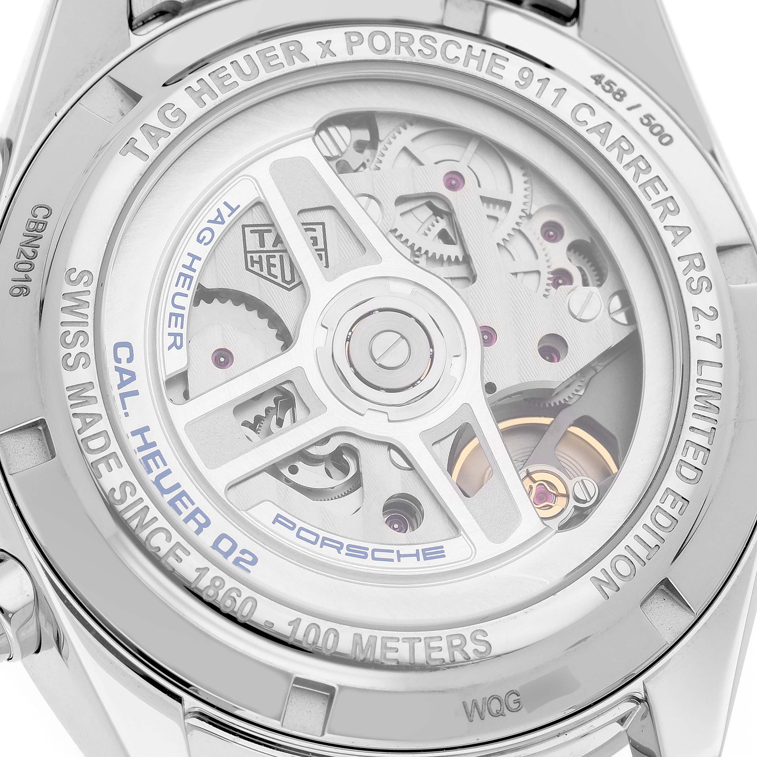 The image shows the back of a Tag Heuer Carrera CBN2016.EB0275 Men's Stainless Steel White Dial watch, highlighting its intricate movement and labeling.