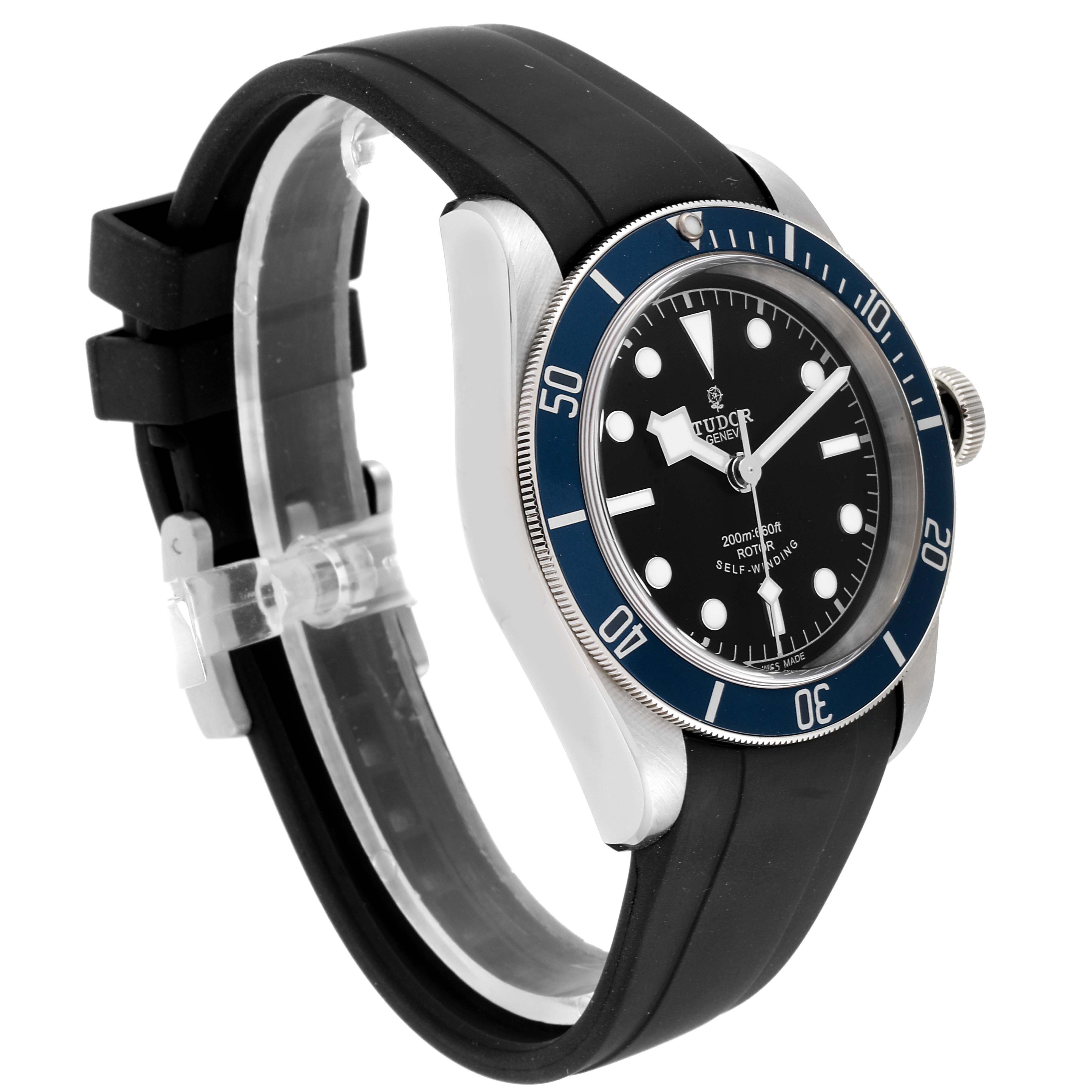 The image shows a Tudor Heritage Black Bay 79220 Men
s Stainless Steel Black Dial 79220 Men
s Stainless Steel Black Dial watch from an angle highlighting its bezel, dial, case, and rubber strap.