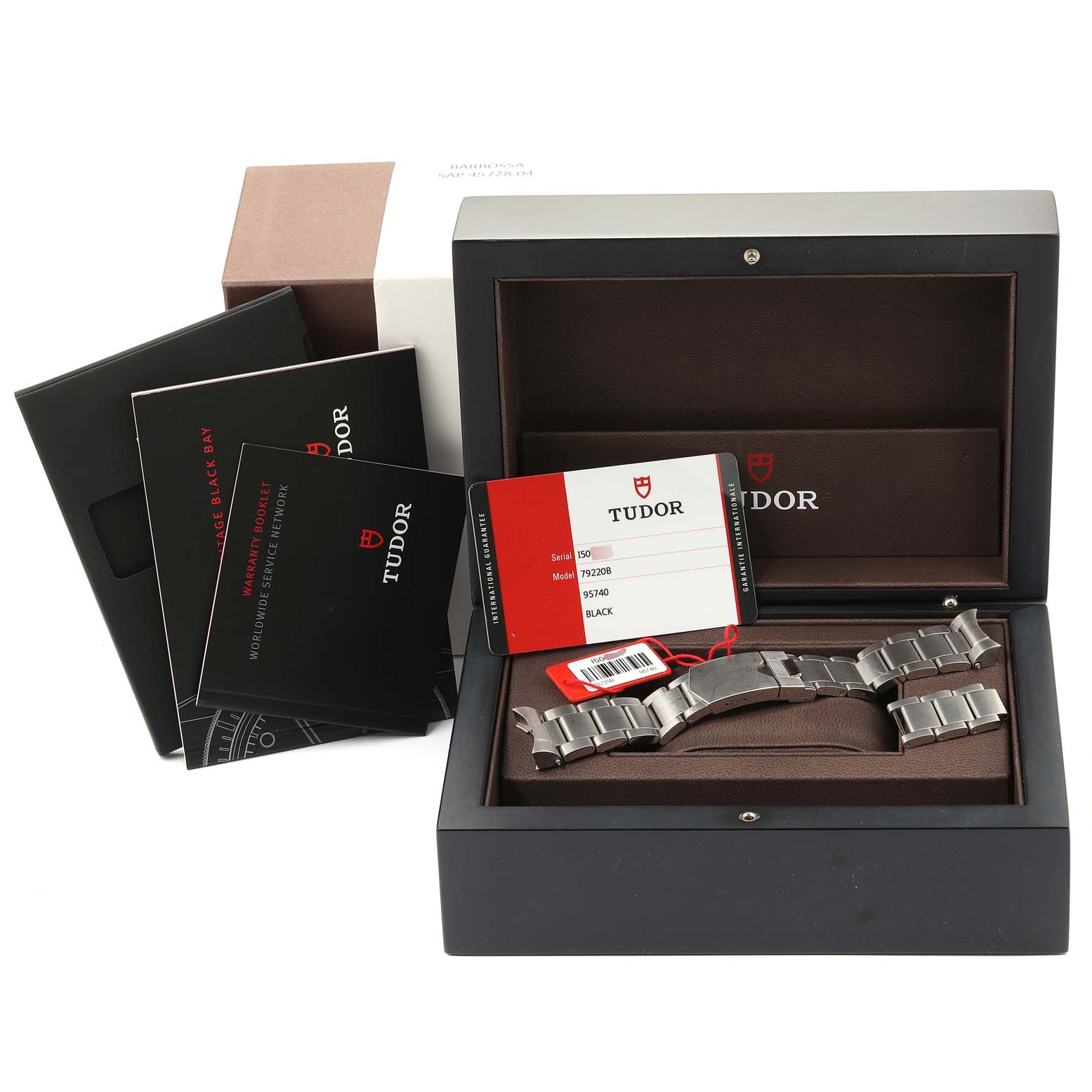 This image shows a Tudor Heritage Black Bay 79220 Men
s Stainless Steel Black Dial 79220 Men
s Stainless Steel Black Dial watch bracelet, warranty booklet, certificate, and packaging at a front angle.