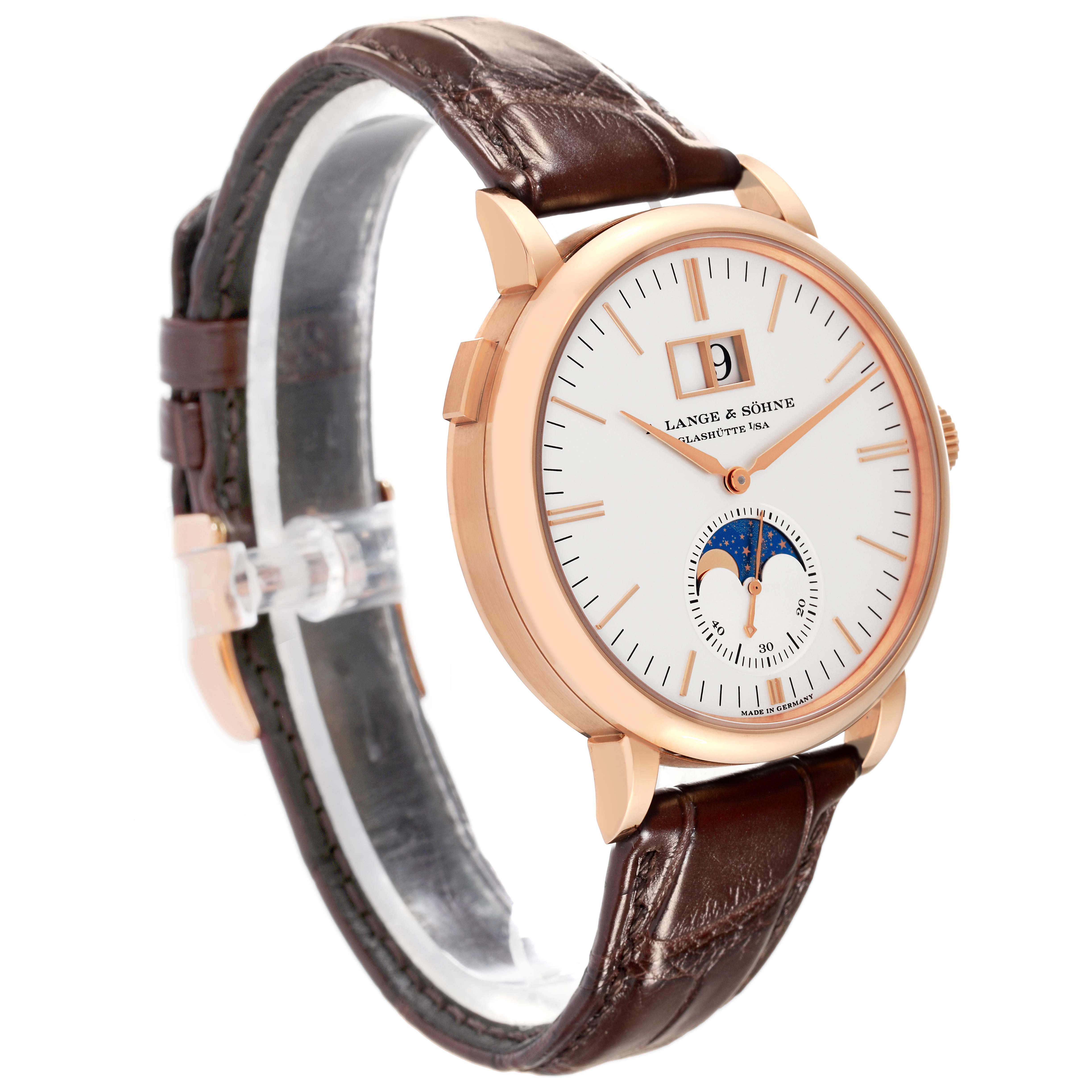 The image shows a side angle of the A. Lange 
Sohne Saxonia 384.032 Men
s Rose Gold Silver Dial watch with a brown leather strap, gold case, and moon phase dial.