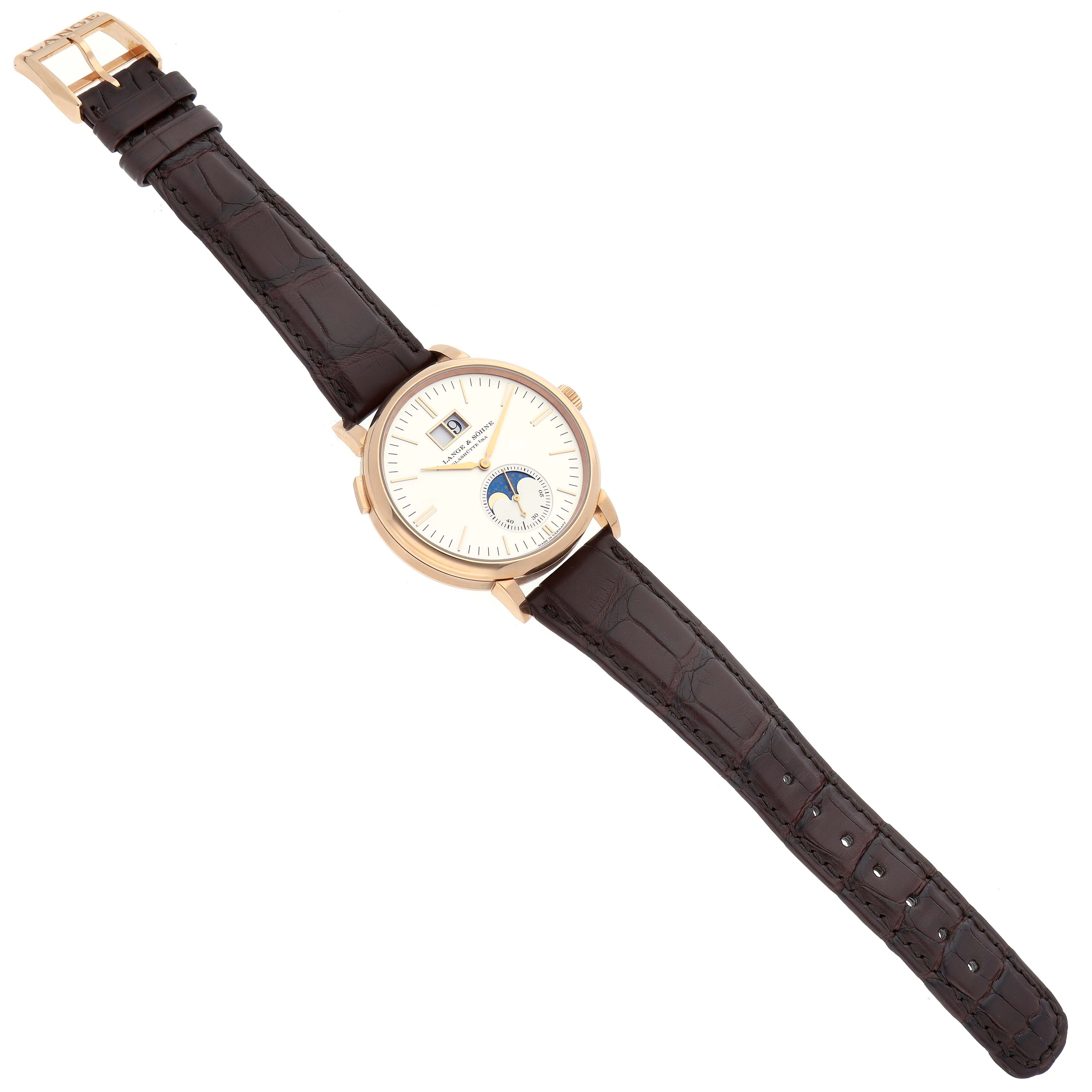 The A. Lange 
Sohne Saxonia 384.032 Men
s Rose Gold Silver Dial watch is shown from a top-down view, displaying the face, strap, and buckle.