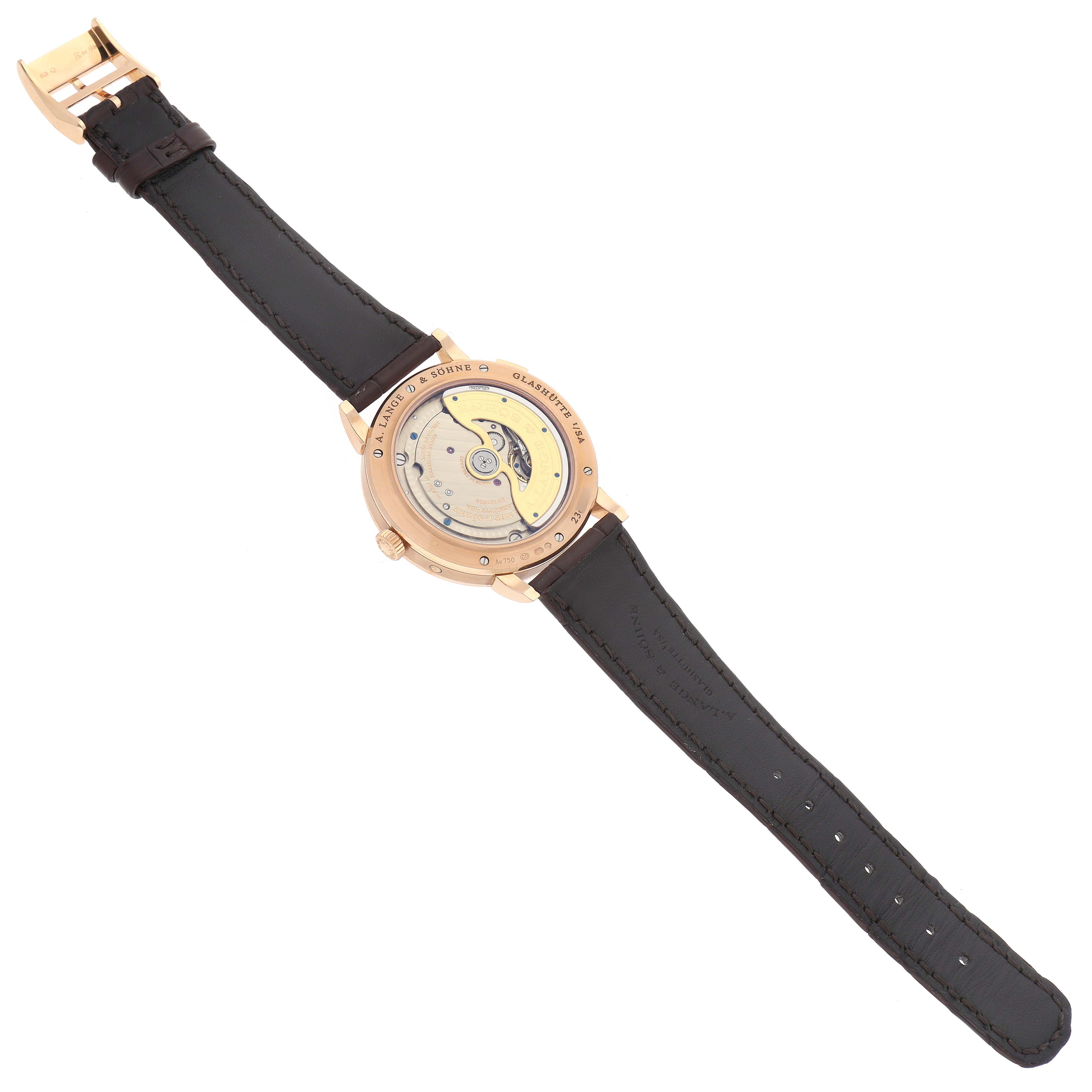 The image shows the back view of the A. Lange 
Sohne Saxonia 384.032 Men
s Rose Gold Silver Dial watch, showcasing its movement and strap.