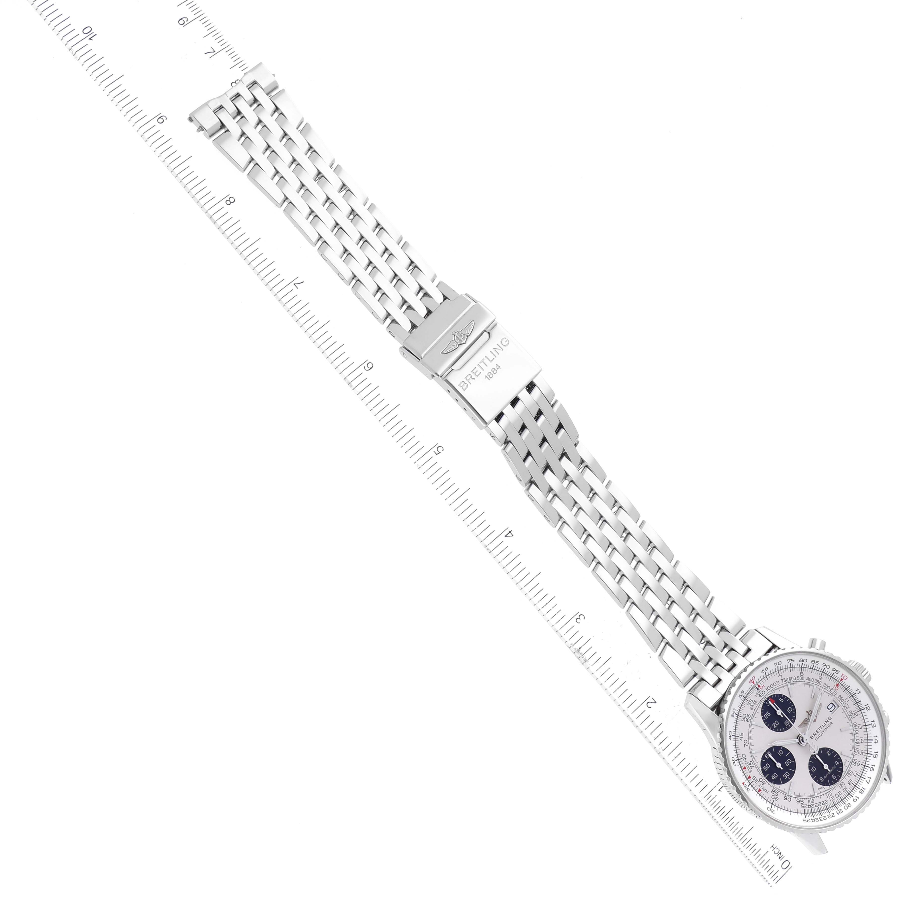 The image shows a top-down view of a Breitling Navitimer A13324 Men's Stainless Steel Silver Dial A13324 Men's Stainless Steel Silver Dial watch, highlighting its metal bracelet and clasp, alongside a ruler for scale.