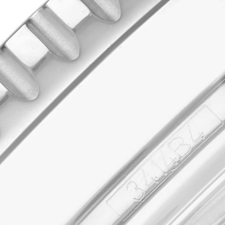 The image shows a close-up of the bezel and part of the case of a Breitling Navitimer A13324 Men's Stainless Steel Silver Dial A13324 Men's Stainless Steel Silver Dial watch.