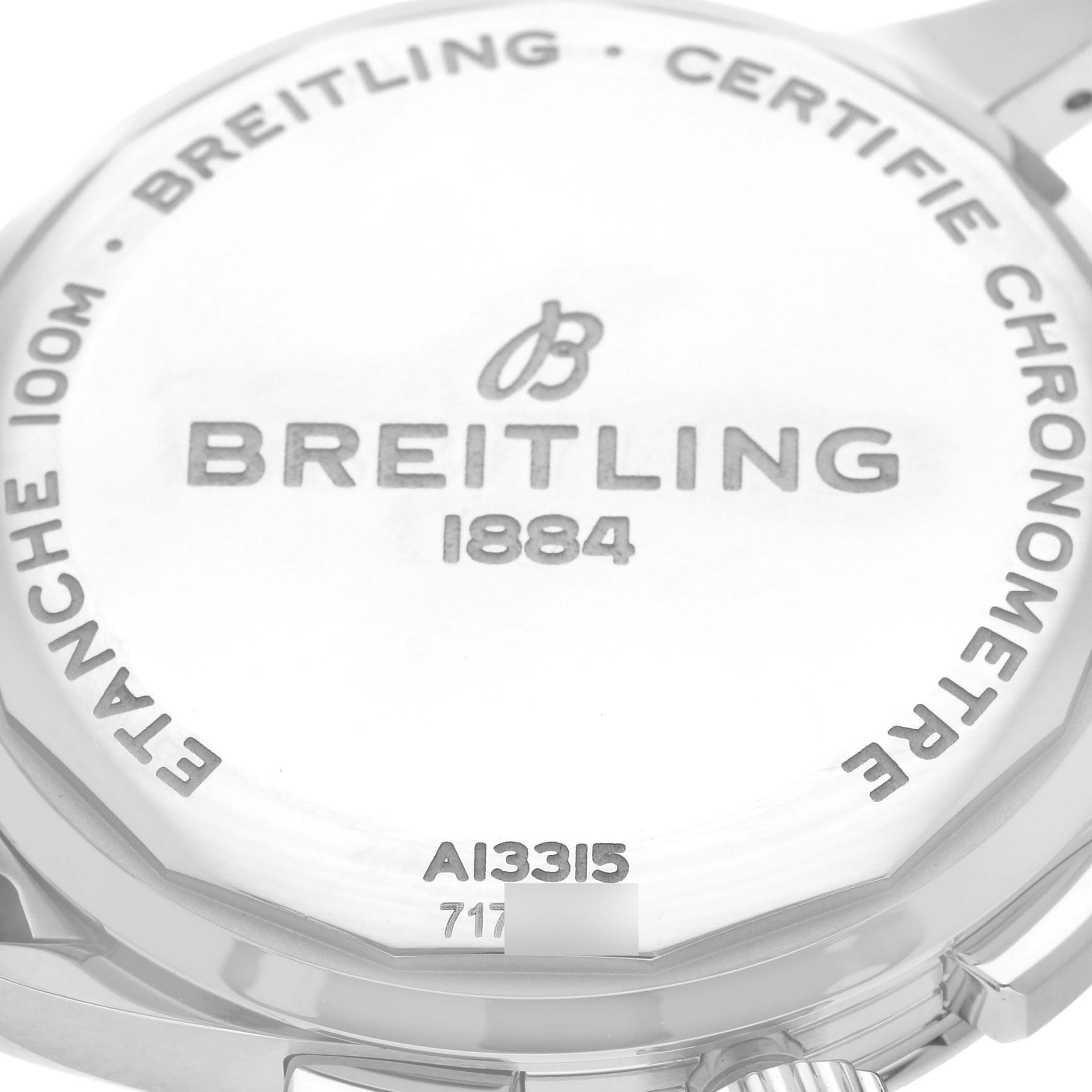 The image shows the back case of the Breitling Premier A13315 Men's Stainless Steel Blue Dial A13315 Men's Stainless Steel Blue Dial model watch, displaying its inscriptions and part of the crown.