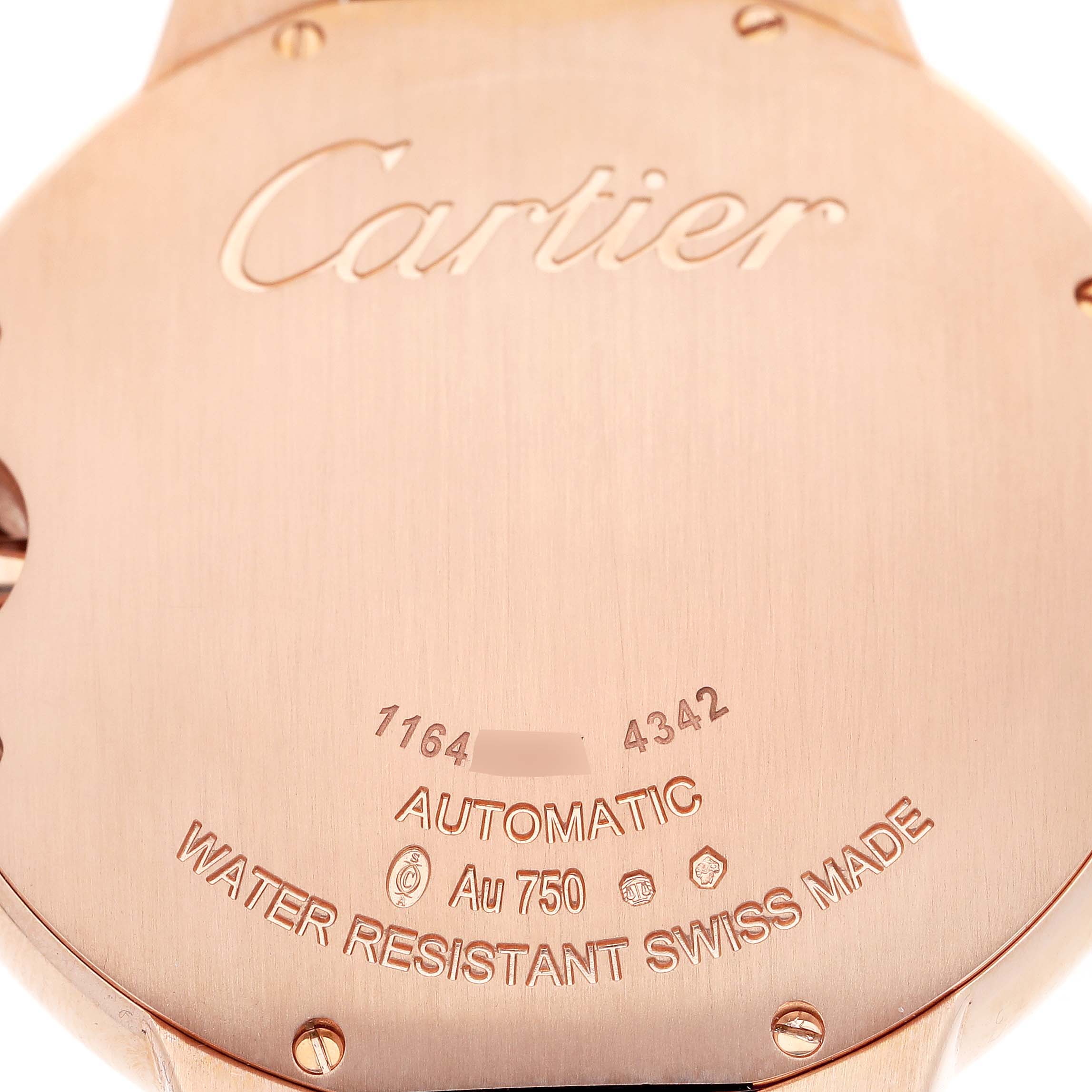 The image shows the back case of the Ballon Bleu model by Cartier, featuring engravings and screws.
