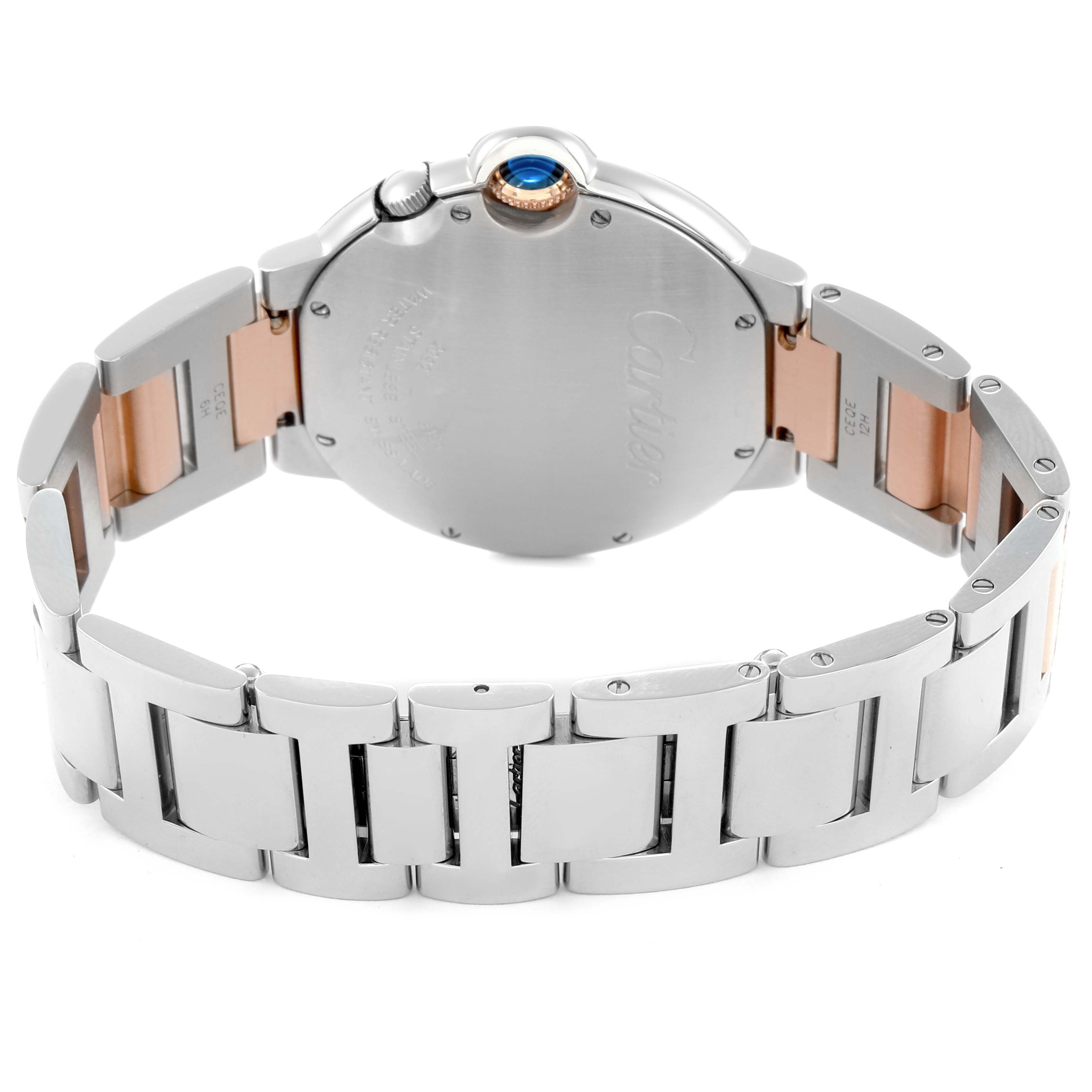 The image shows the back and side view of a Cartier Ballon Bleu W6920027 Men
s Steel and Gold (two tone) Silver Dial watch, highlighting its bracelet and crown with a blue gem.