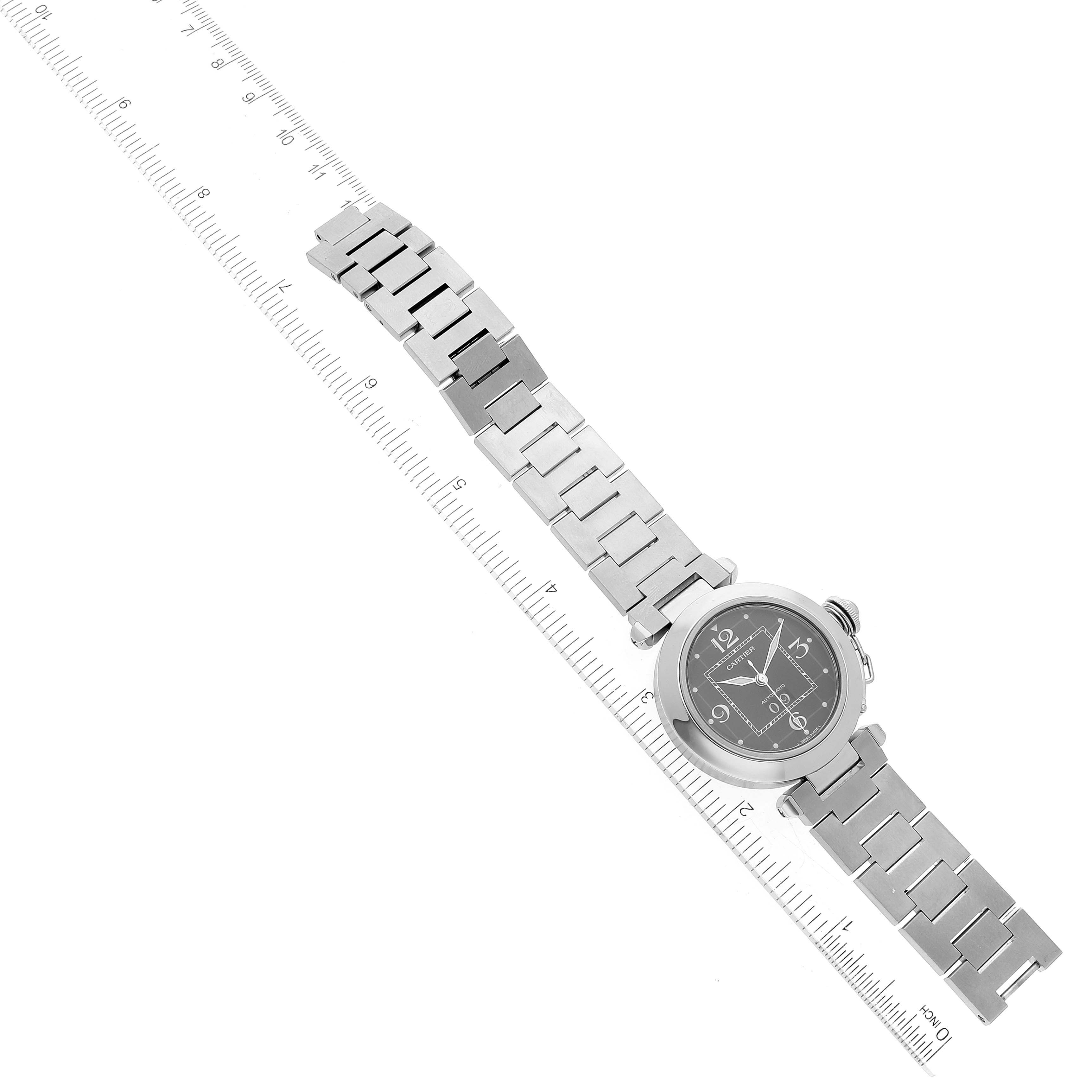 This image shows a top-down view of the Cartier Pasha W31053M7 Women's Stainless Steel Black Dial W31053M7 Women's Stainless Steel Black Dial watch with its bracelet aligned along a ruler.