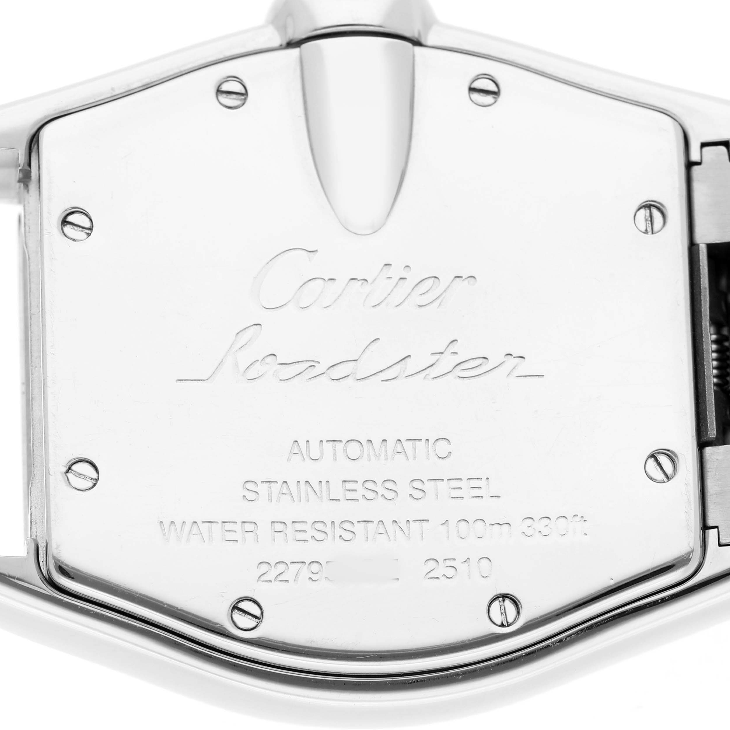 The image shows the back of a Cartier Roadster W62025V3 Men's Stainless Steel Silver Dial watch, featuring engravings and screws.